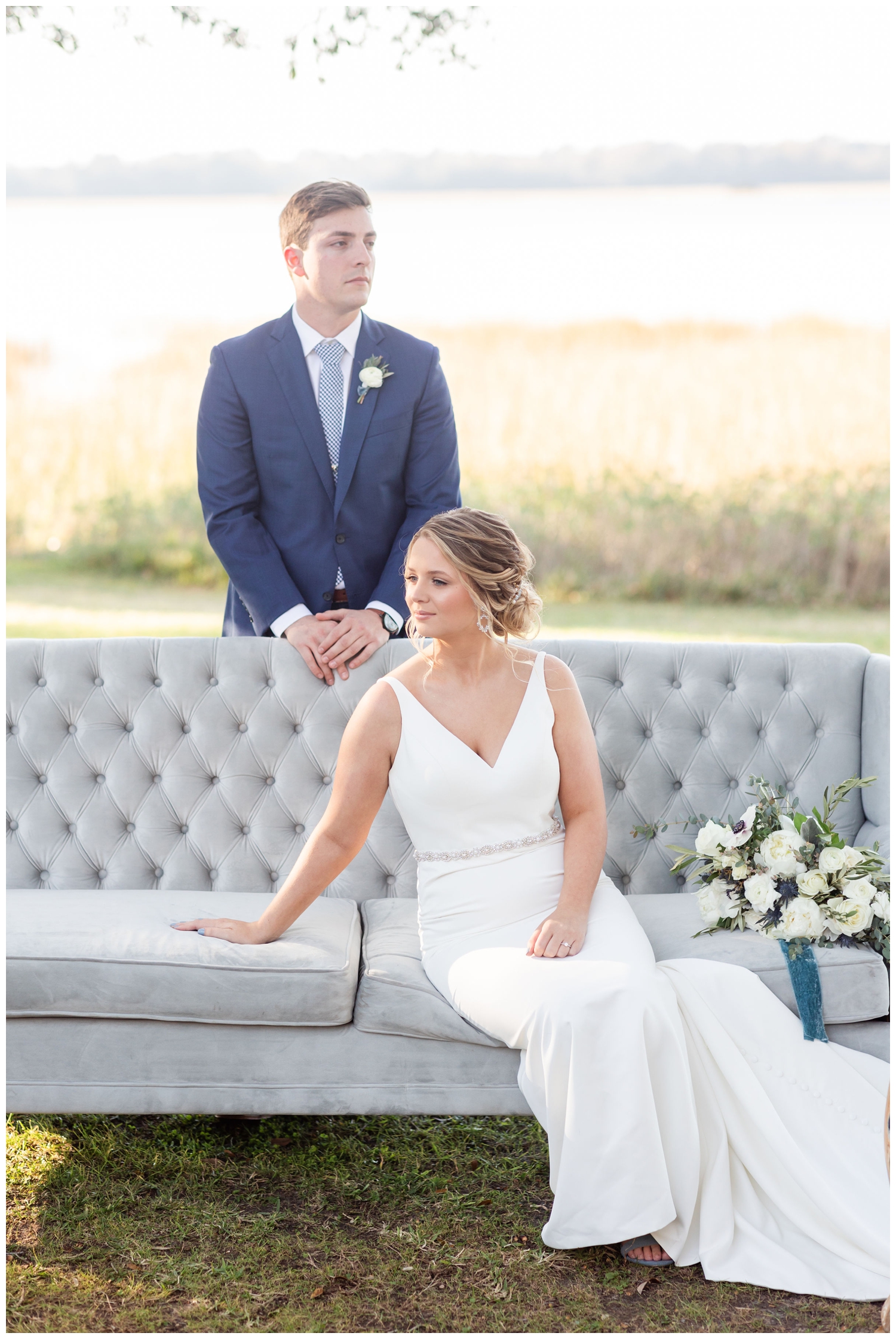 bride and groom on a gray couch