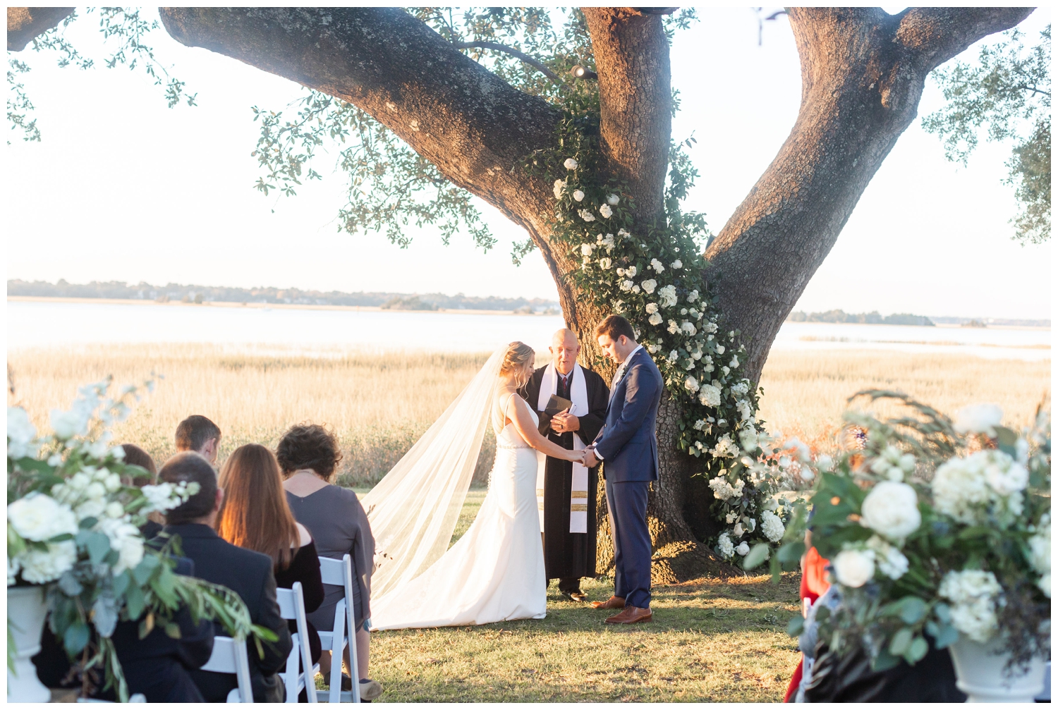 outdoor Charleston micro wedding ceremony in front of oak tree at The River House Lowndes Grove
