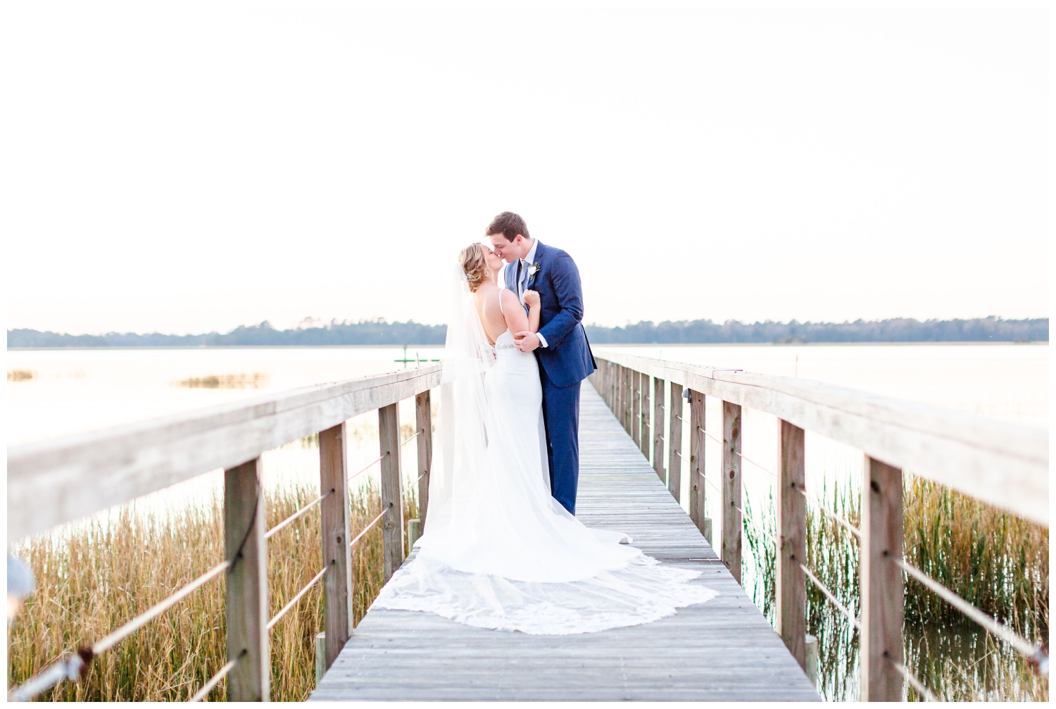 bride and groom kissing on the dock in Charleston