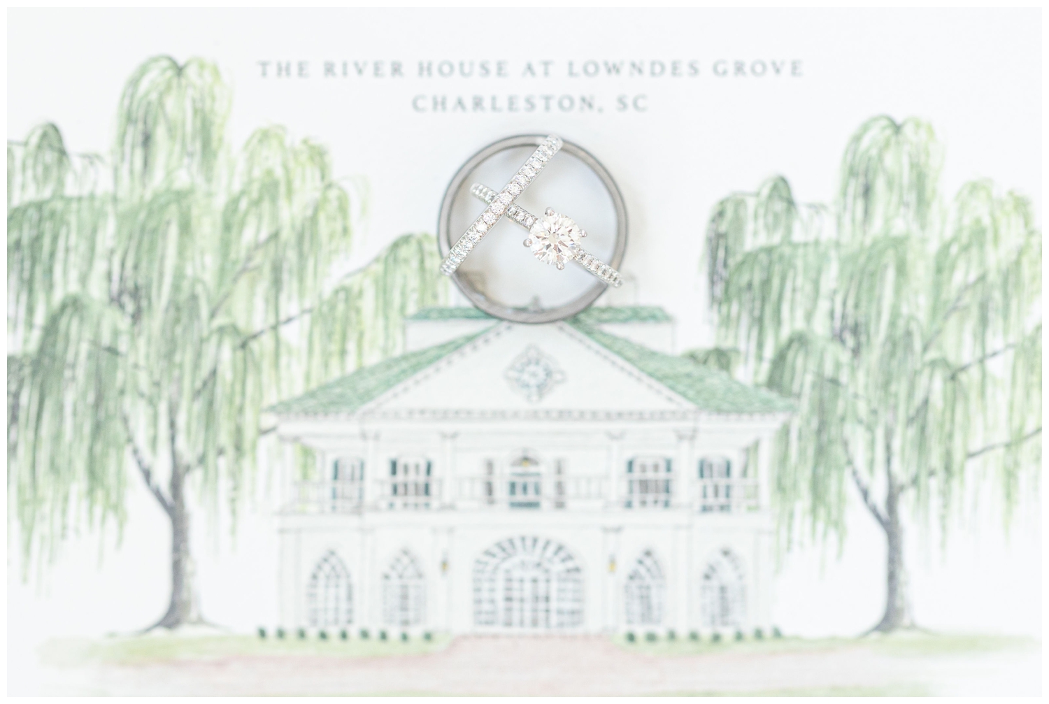 ring shot on top of an invitation suite with drawing of The River House at Lowndes Grove in Charleston