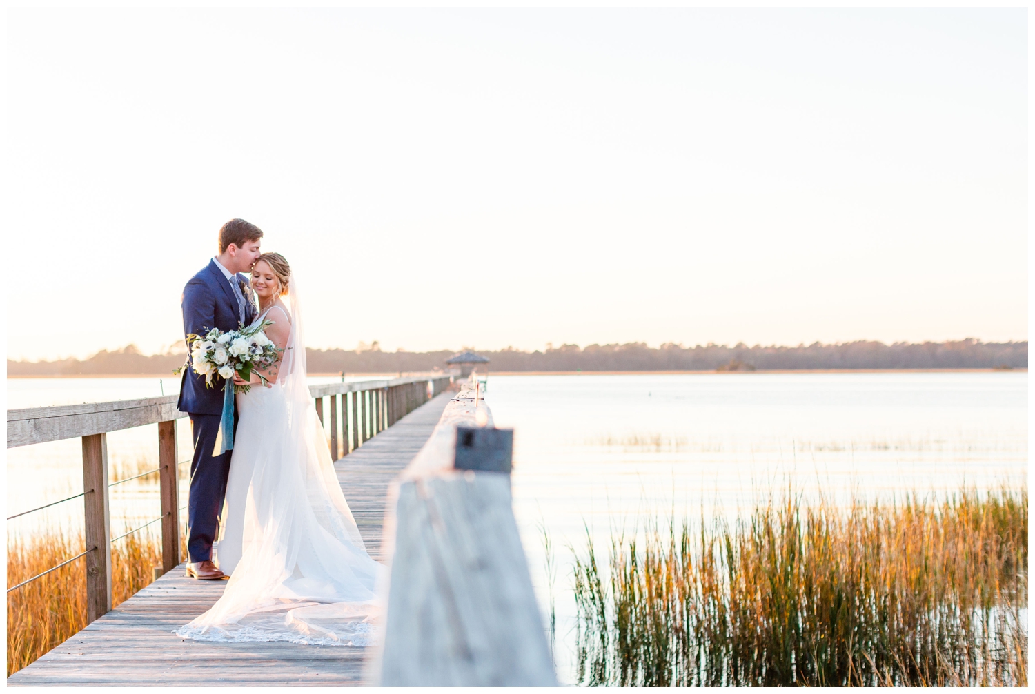 bride and groom hugging on a dock on the waterfront in Charleston, South Carolina