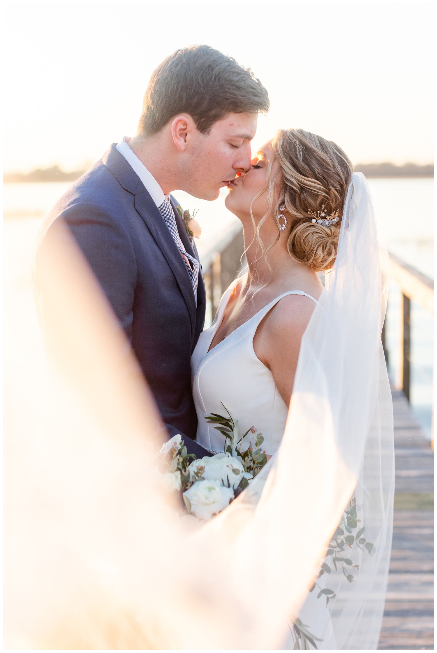 veil shot of a married couple kissing