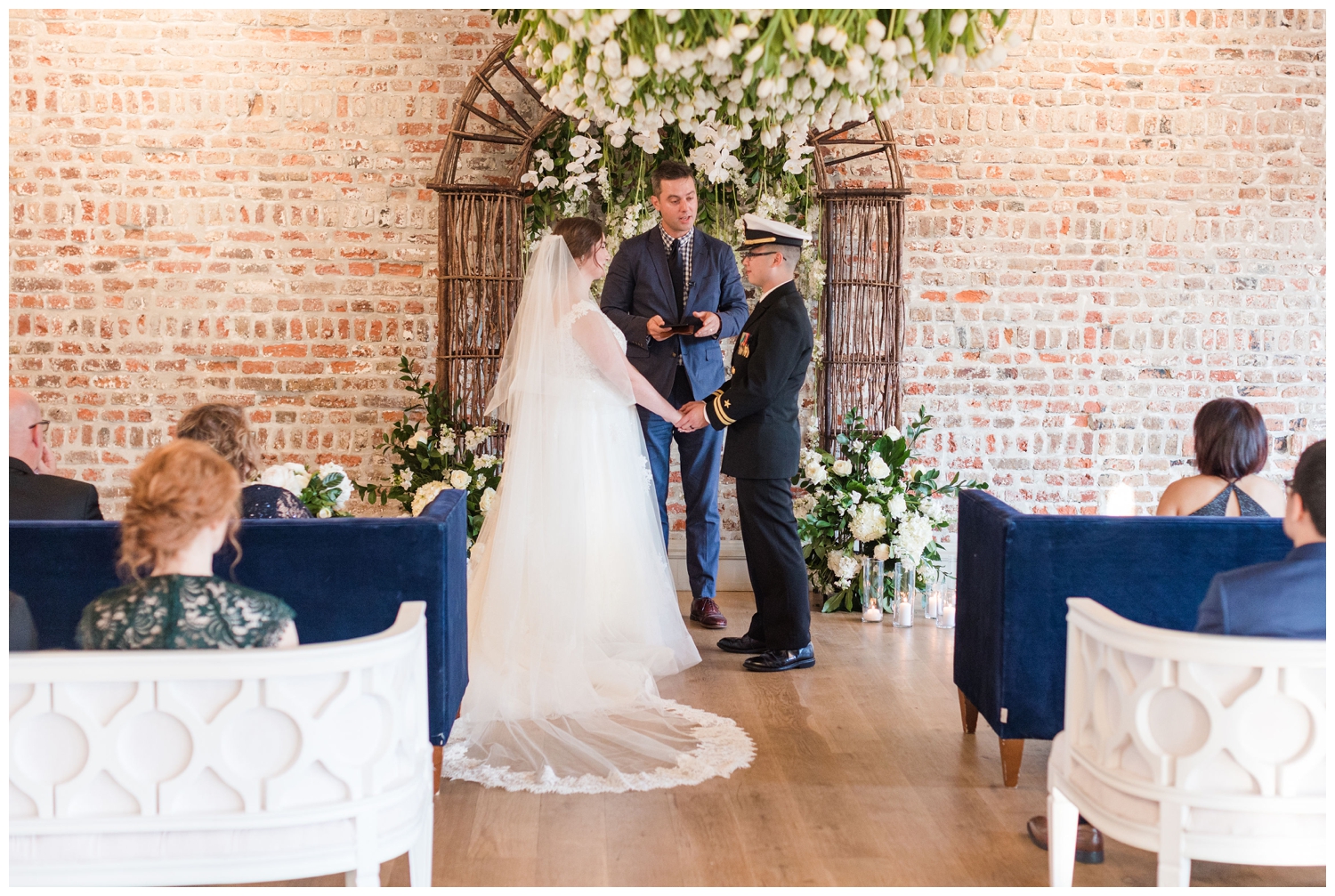 bride and groom ceremony for micro wedding inside Merchants Hall in Charleston South Carolina
