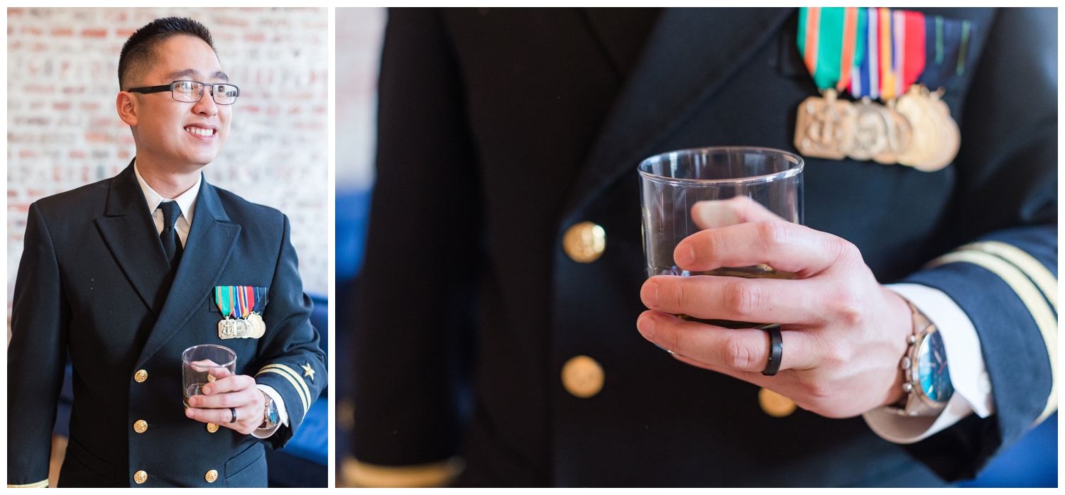 groom at reception holding a drink