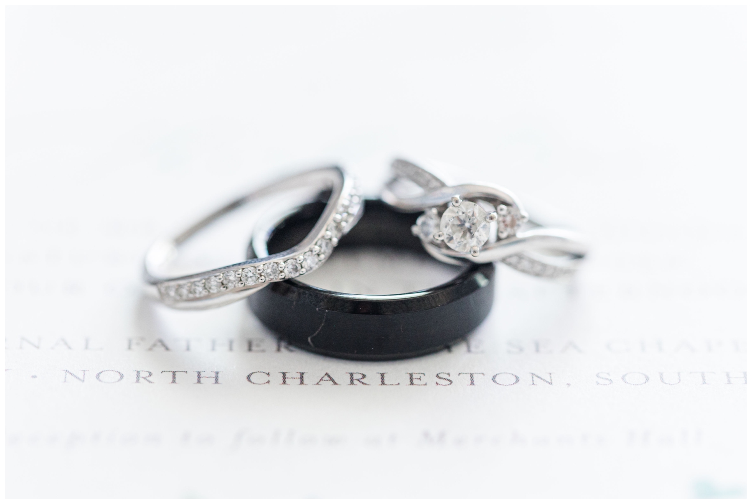close up of wedding ring shot on white invitation suite