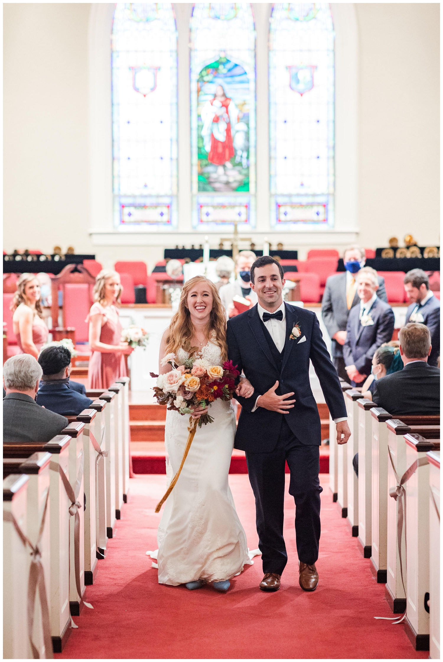 newlyweds walking out of a ceremony at John Wesley United Methodist church