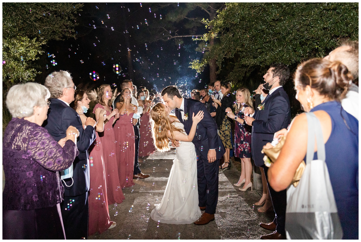 bride and groom kissing during bubble exit of a colorful fall Charleston wedding