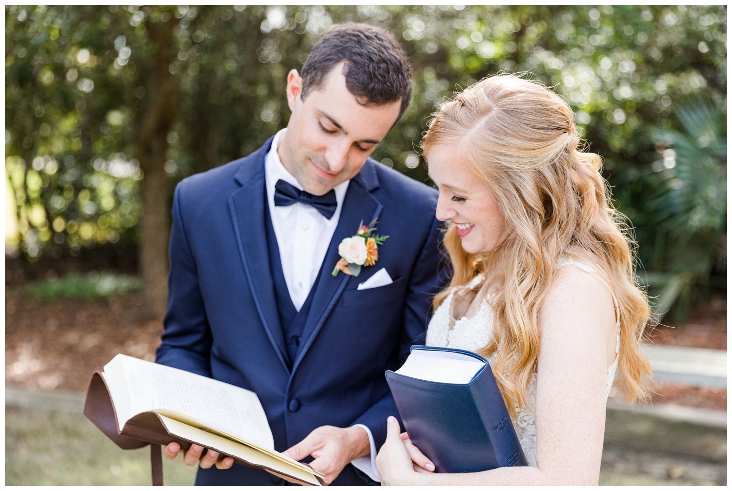 bride and groom looking at bible outside the Founders Hall