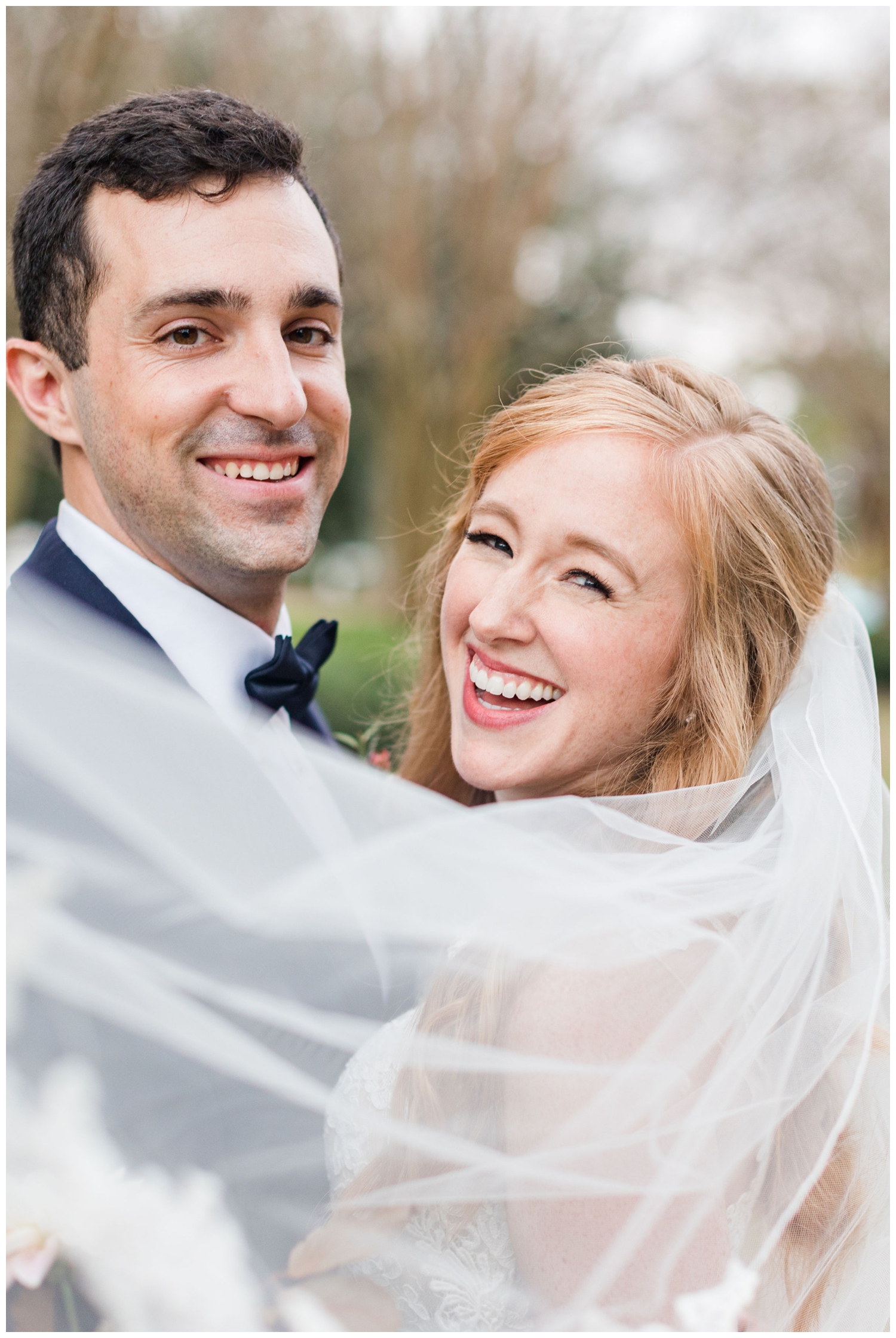 bride and groom laughing veil shot