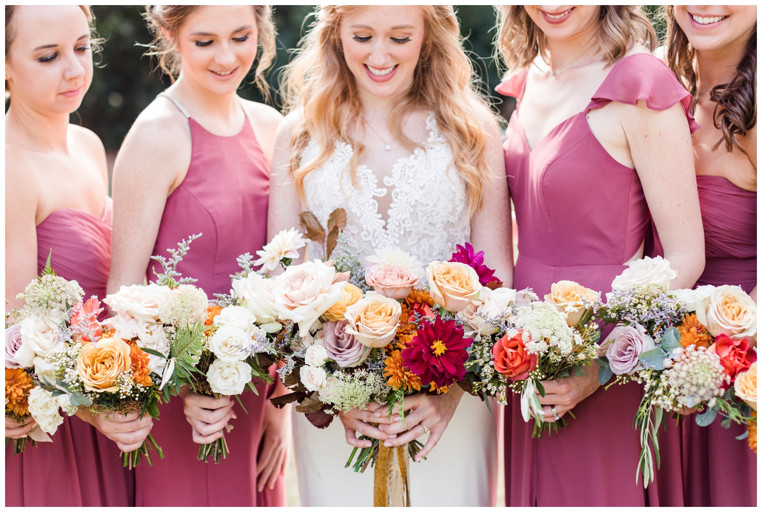 bride and bridesmaids looking at colorful fall Charleston wedding bouquet