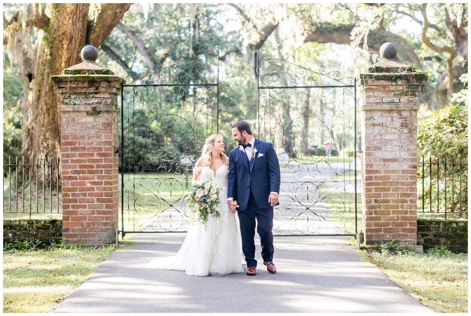 bride and groom portrait by gate at Legare Waring House