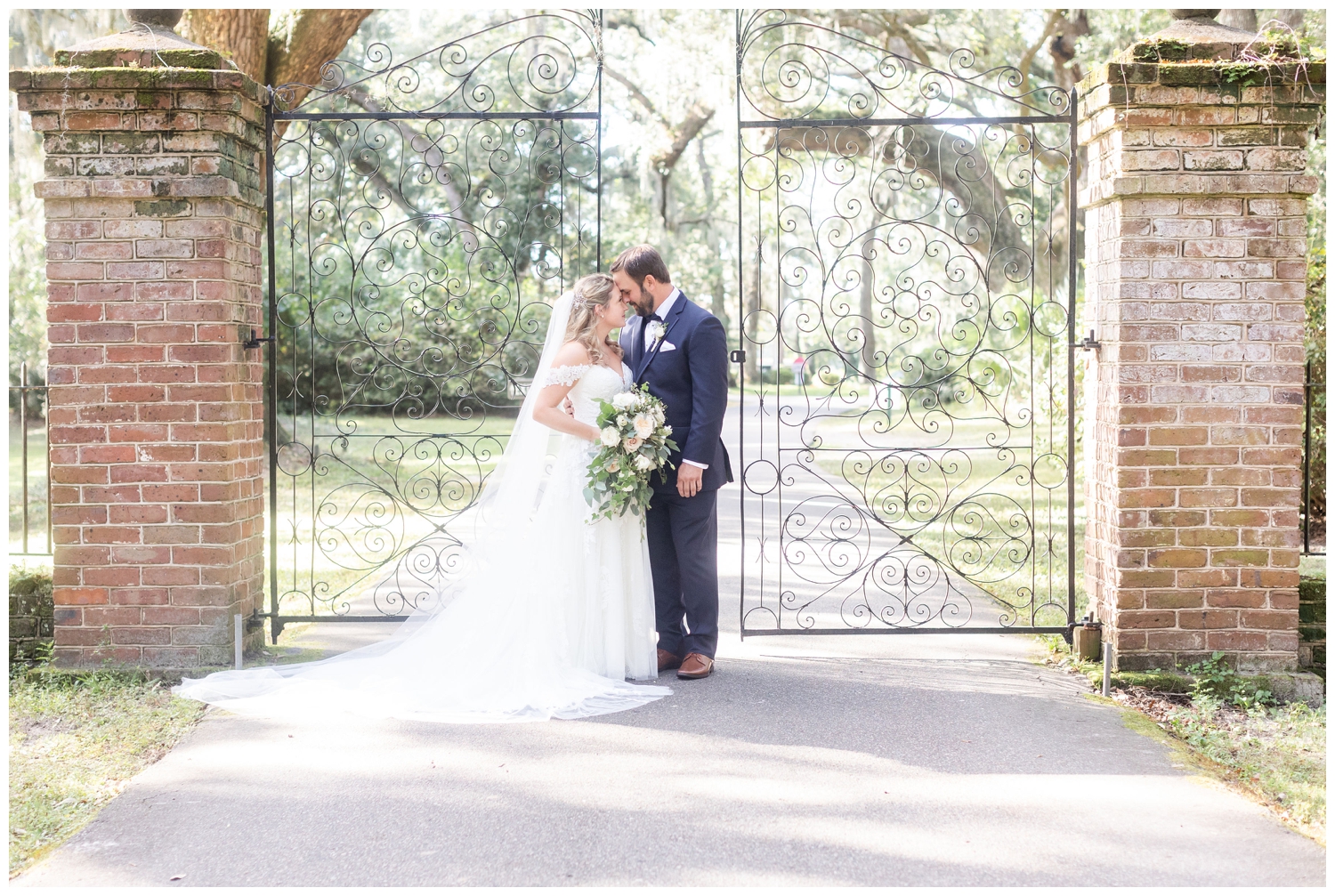 bride and groom portrait outside the gate at Legare Waring House wedding venue