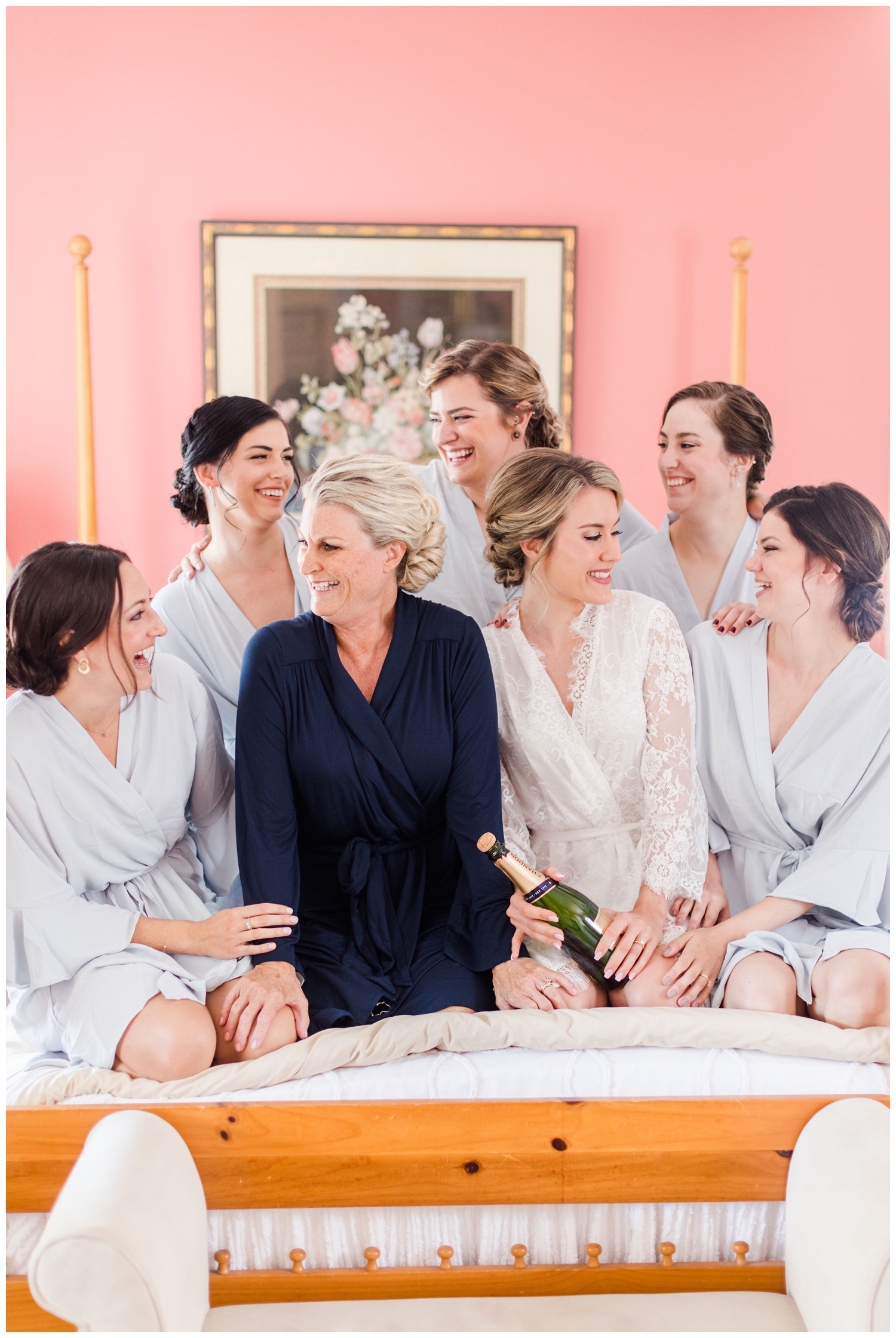 bride and bridesmaids laughing while getting ready
