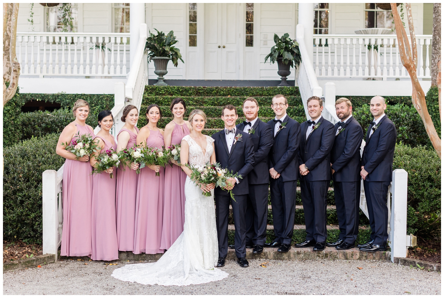 bridal party in blush dresses and black tux outside Old Wide Awake