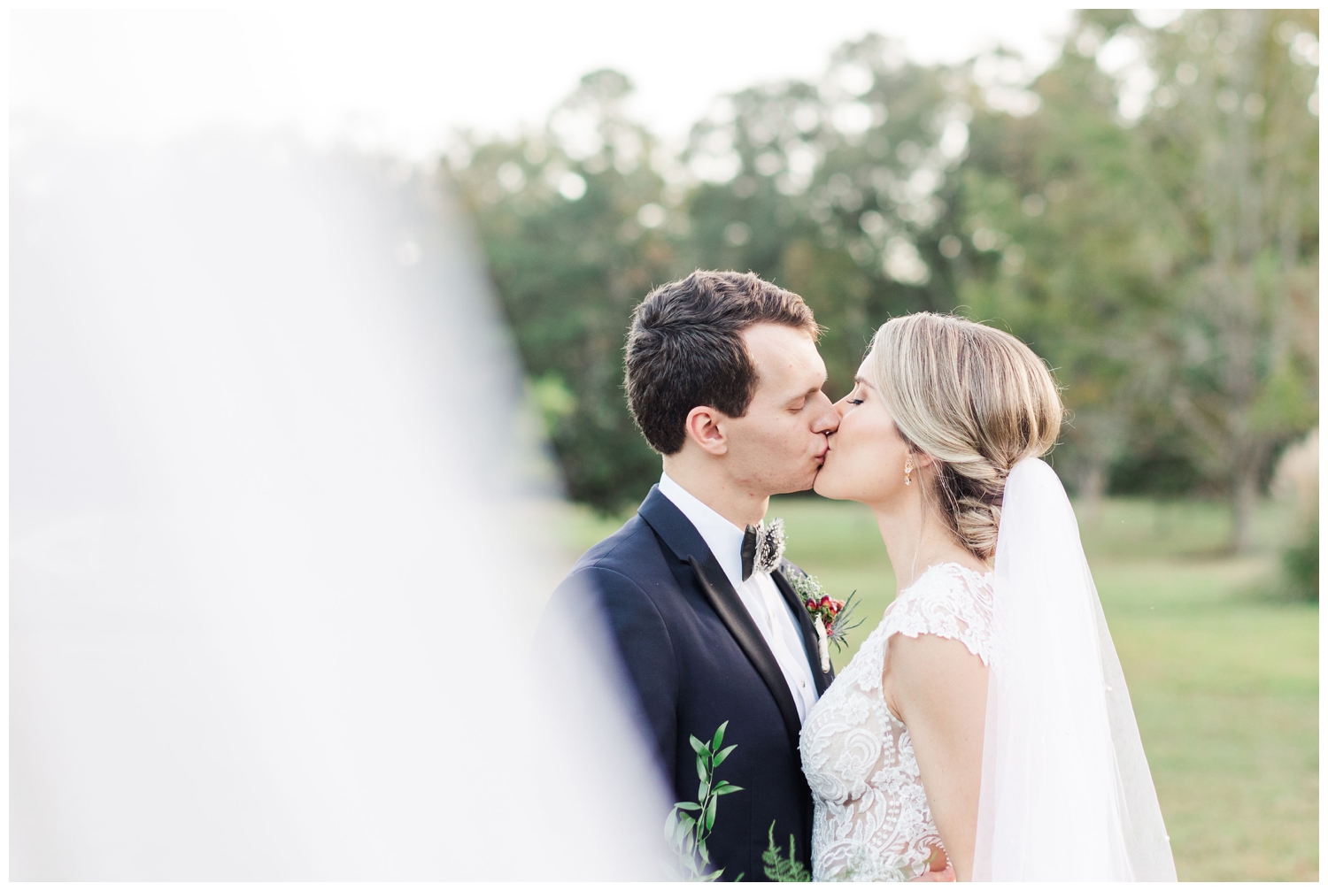 bride and groom kissing and veil shot outside Old Wide Awake wedding venue