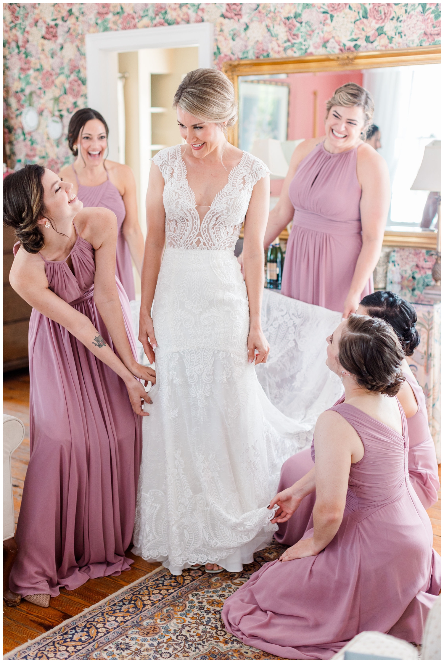 bridesmaids fluffing brides dress