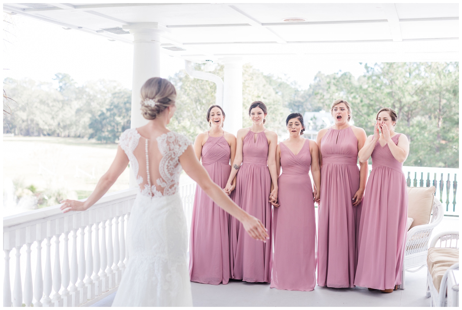 brides first look with bridesmaids in rose gowns
