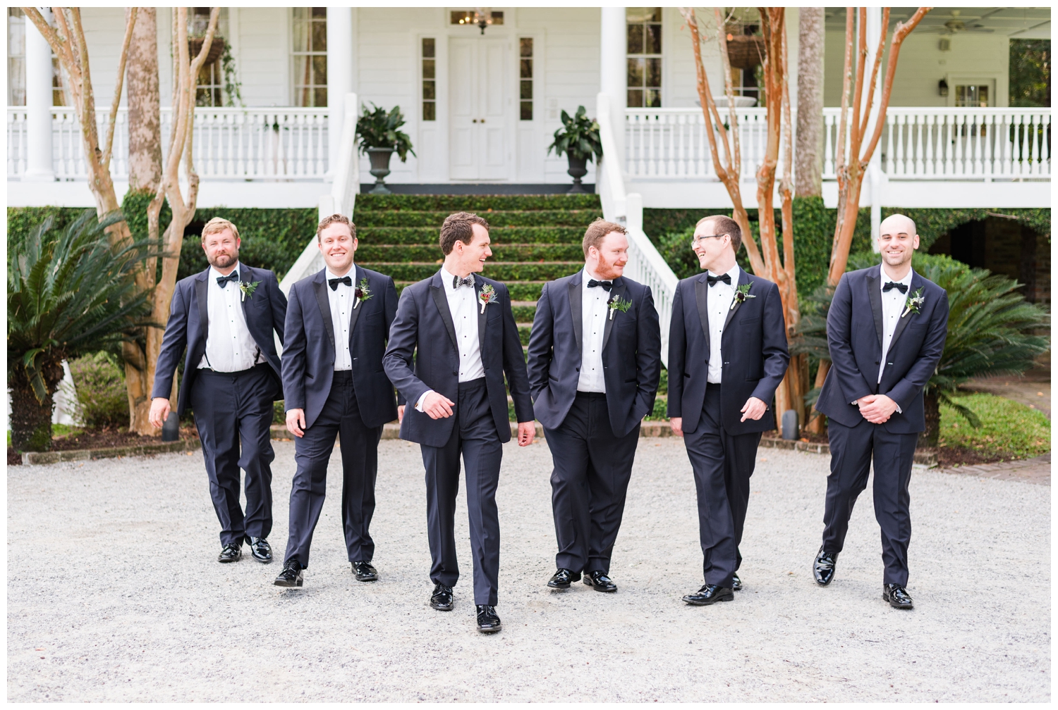 groom and groomsmen in black tux outside Old Wide Awake wedding venue