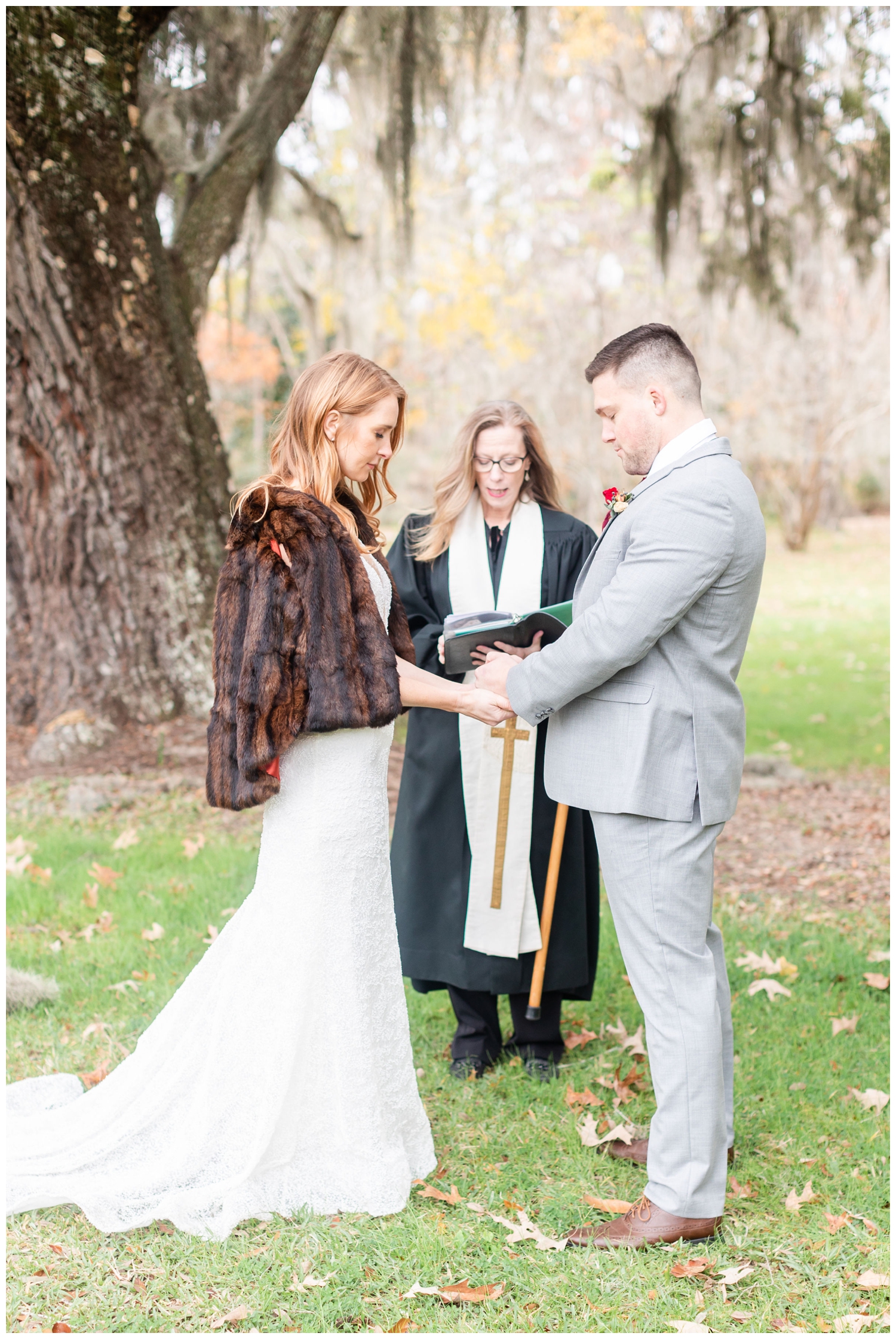 bride and groom praying during intimate Charleston winter elopement ceremony