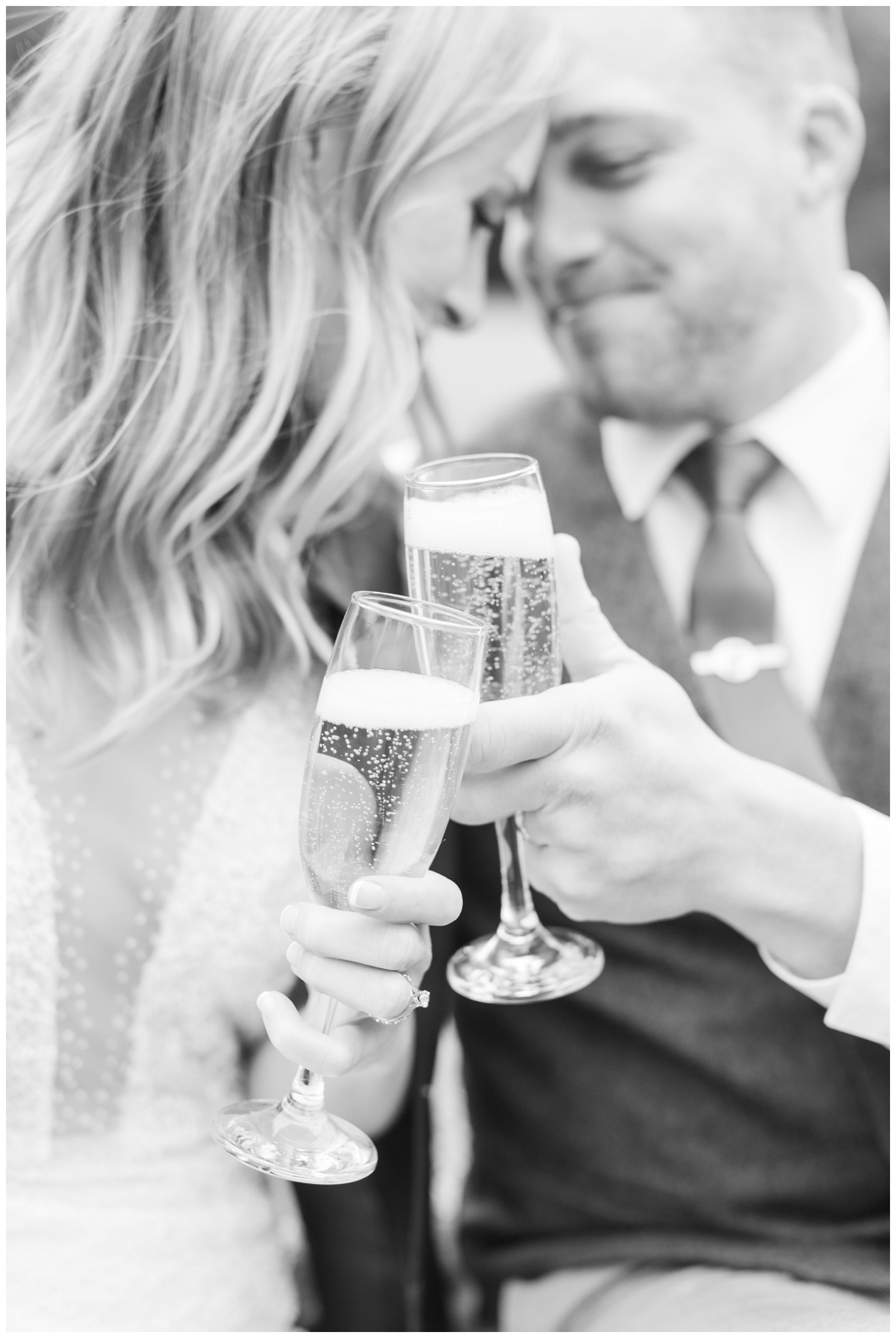 bride and groom toasting champagne flutes