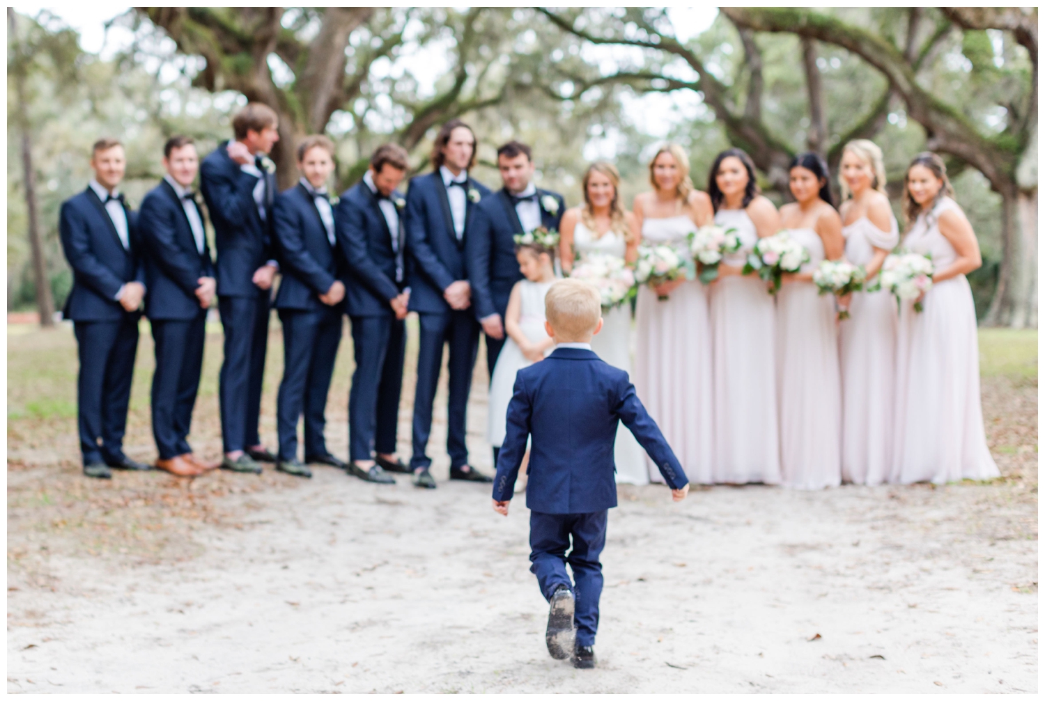 ring bearer running to the bridal party at at Sea Pines Resort wedding venue