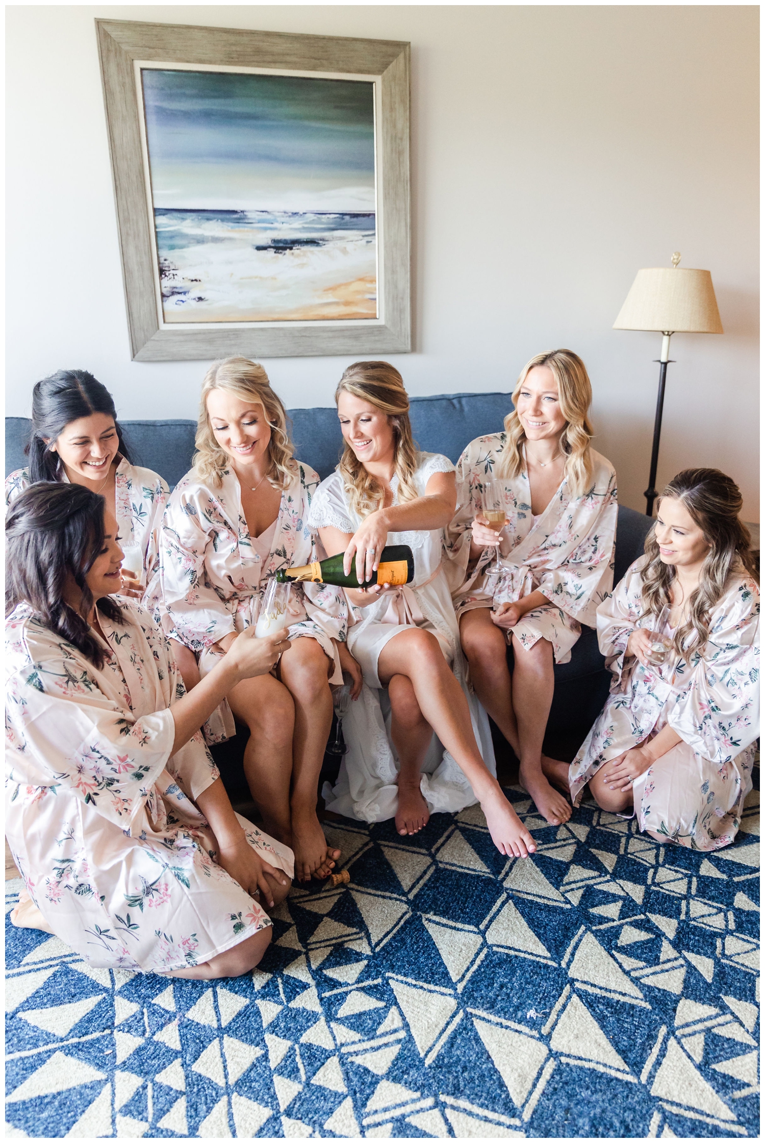 bride and bridesmaids drinking champagne in matching pajamas for a Sea Pines Resort wedding