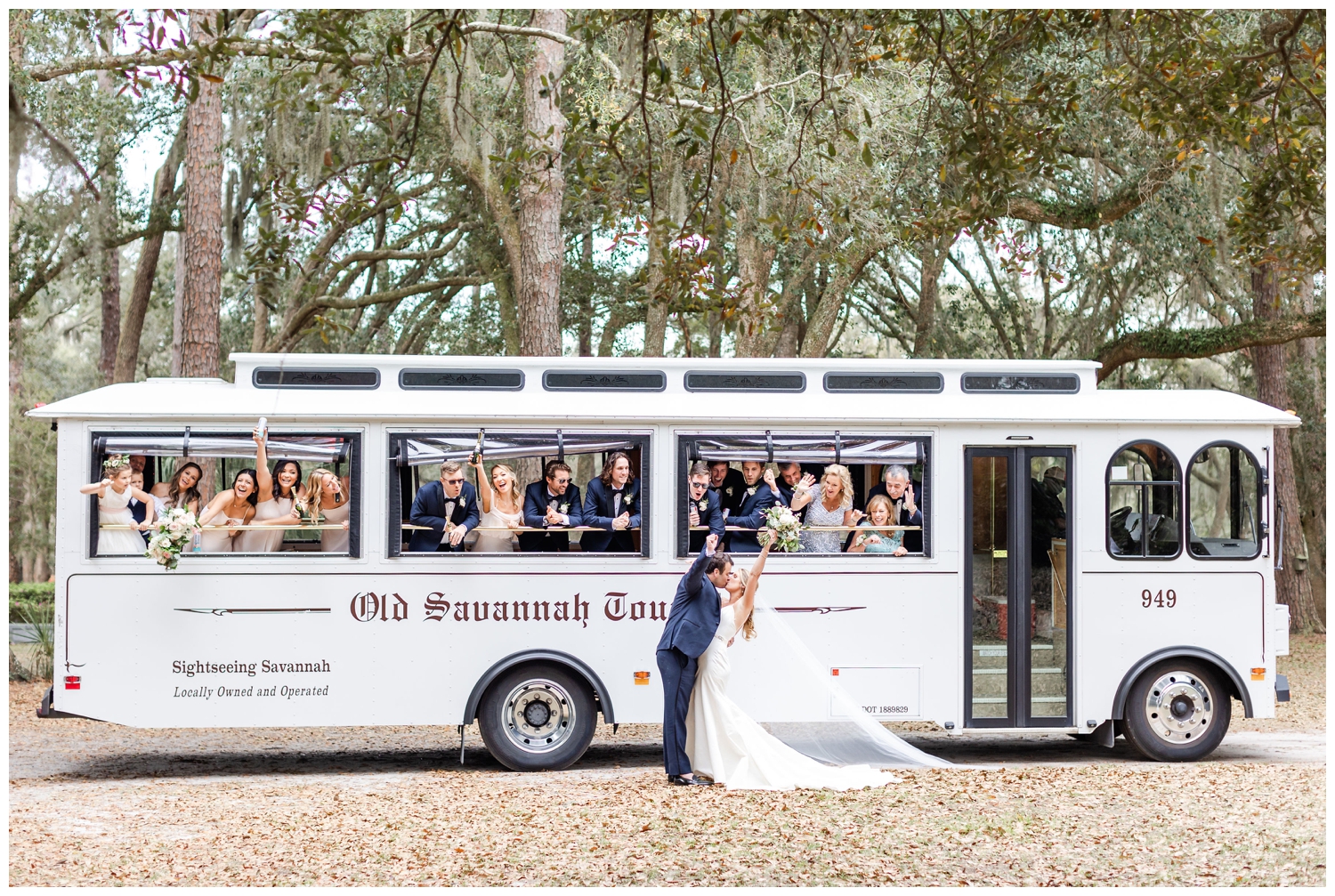 bride and groom kissing in front of a bus with the bridal party at Sea Pines Resort wedding venue