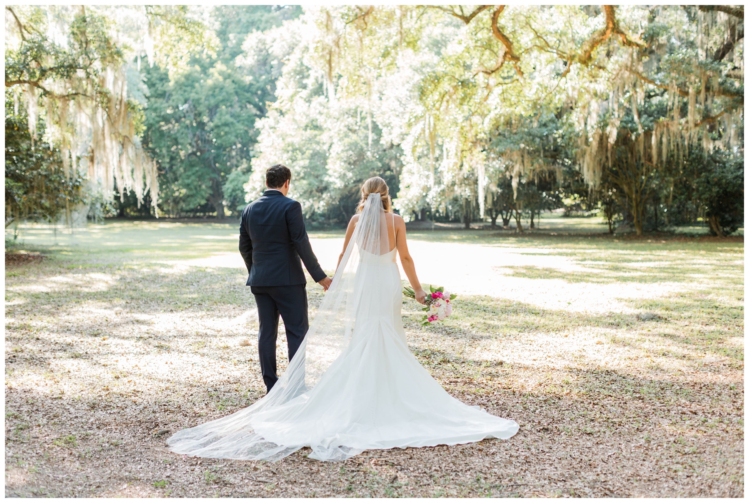 bride and groom walking away from camera under trees at Sea Pines Resort in Hilton Head