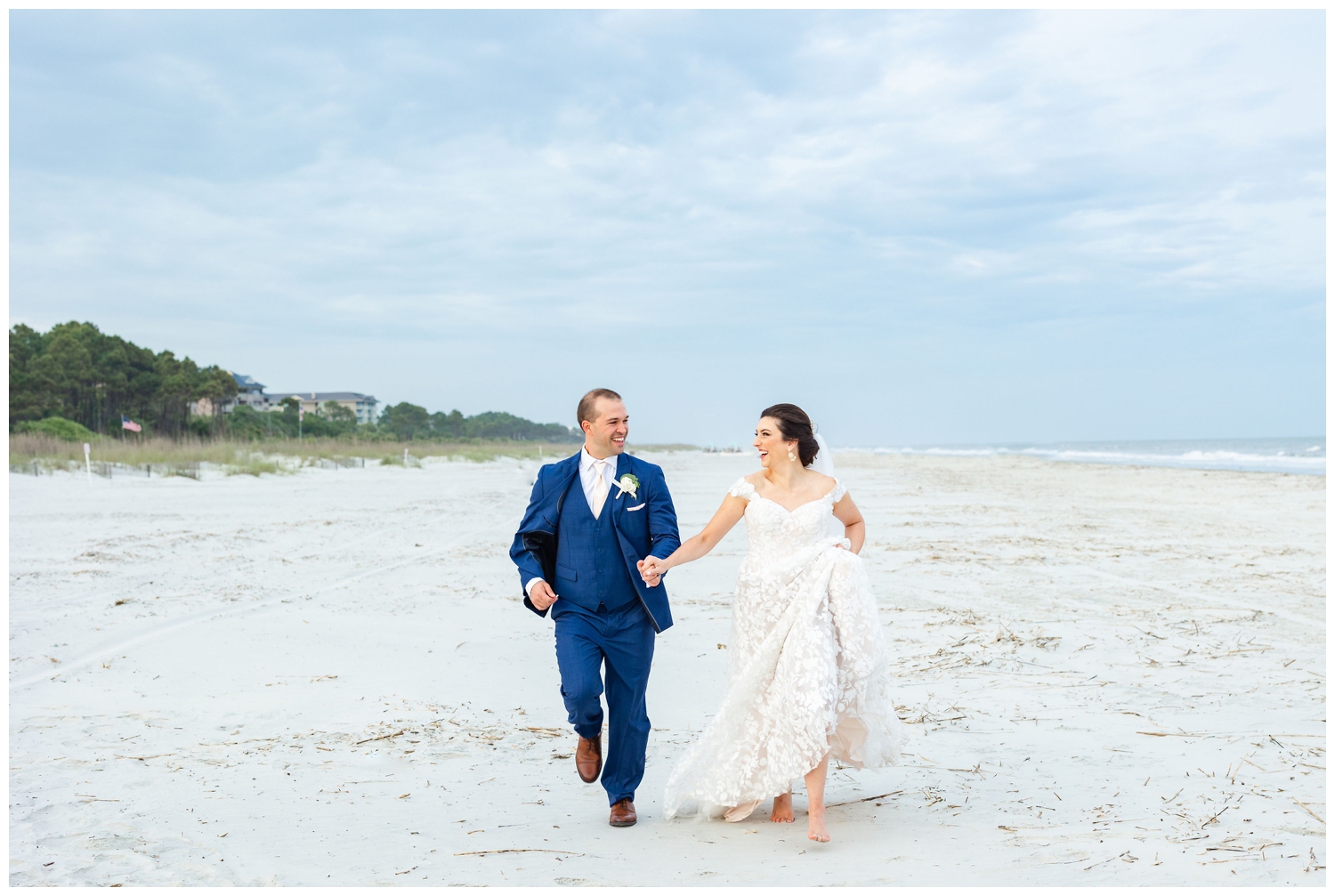bride and groom running on the beach at Hilton Head