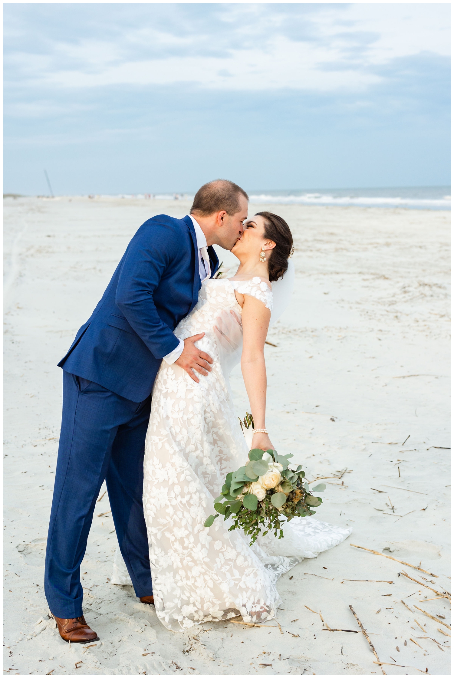 groom dipping his bride on the beach at intimate Hilton Head wedding