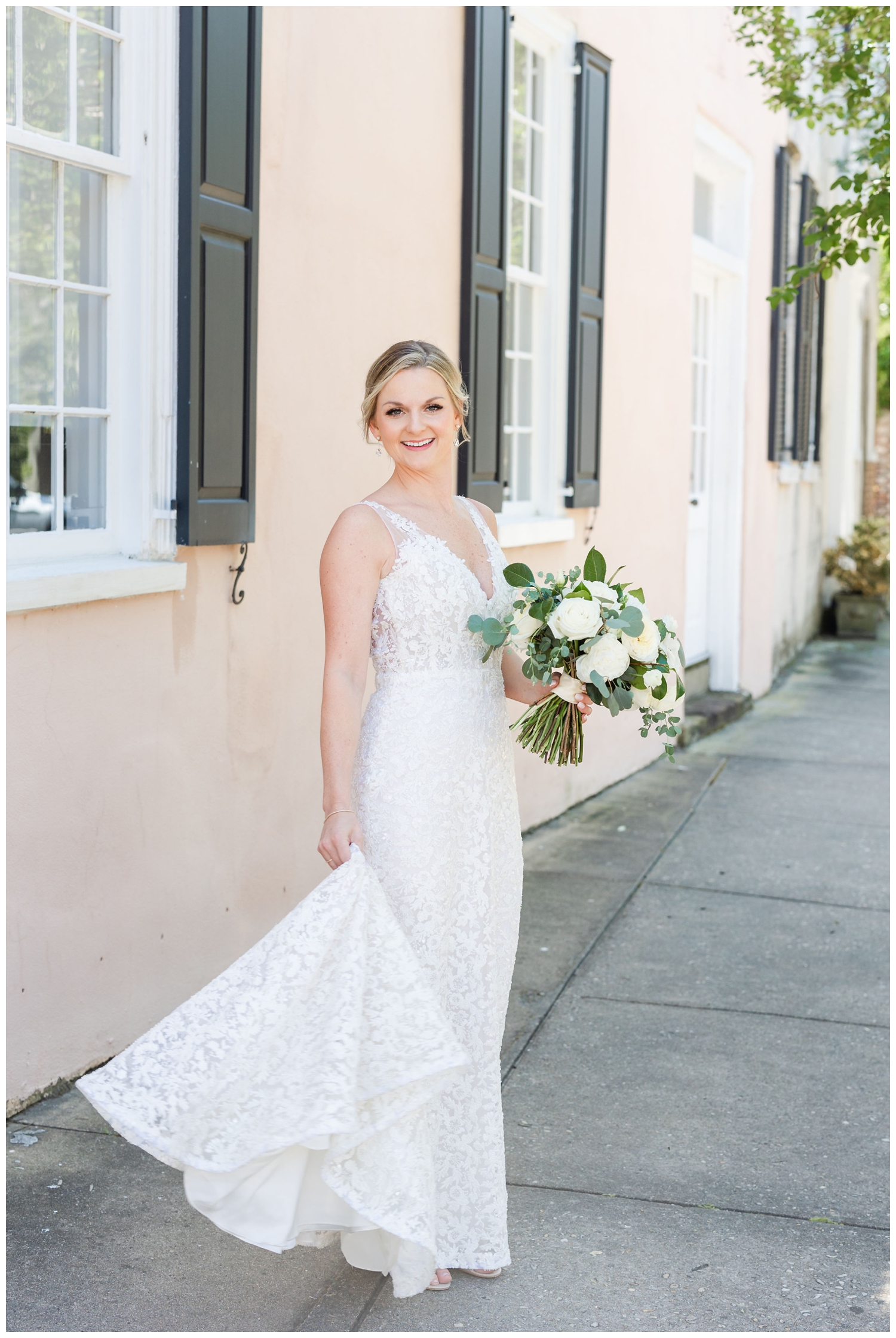 bride twirling wedding dress holding all white bouquet