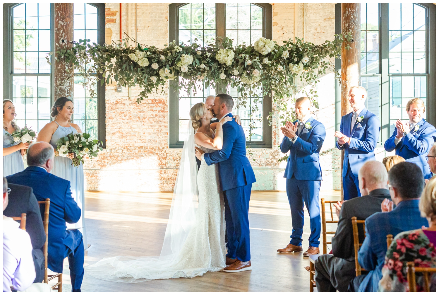 newlywed kiss during ceremony inside The Cedar Room Charleston Wedding