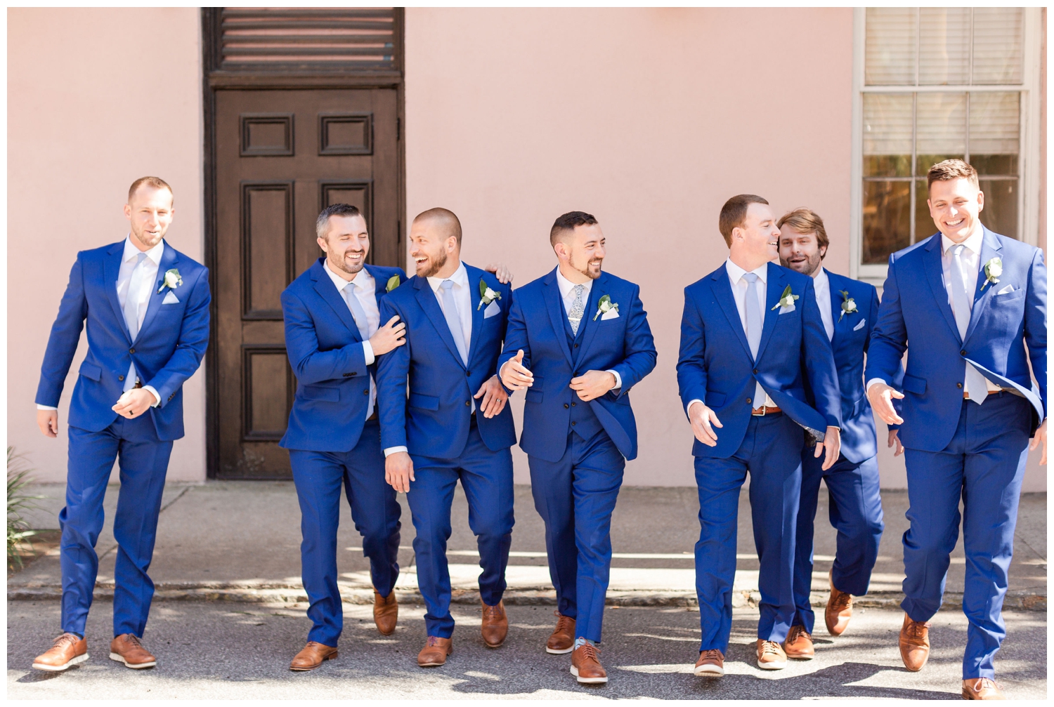groom and groomsmen in blue tuxes walking in Charleston