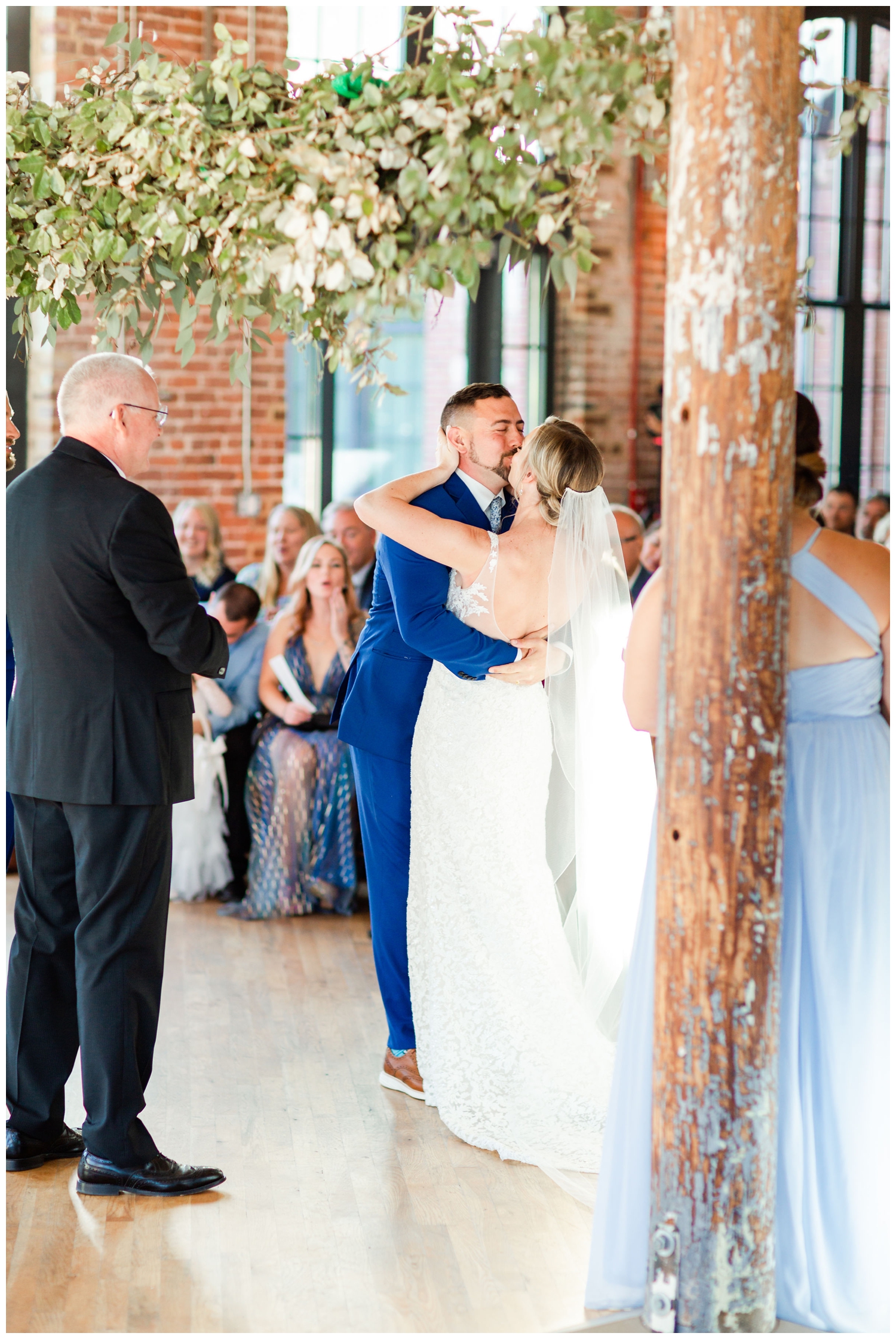 newlywed kiss during ceremony in The Cedar Room Charleston Wedding