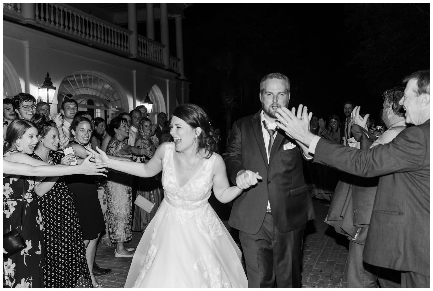 black and white photo of bride and groom exit