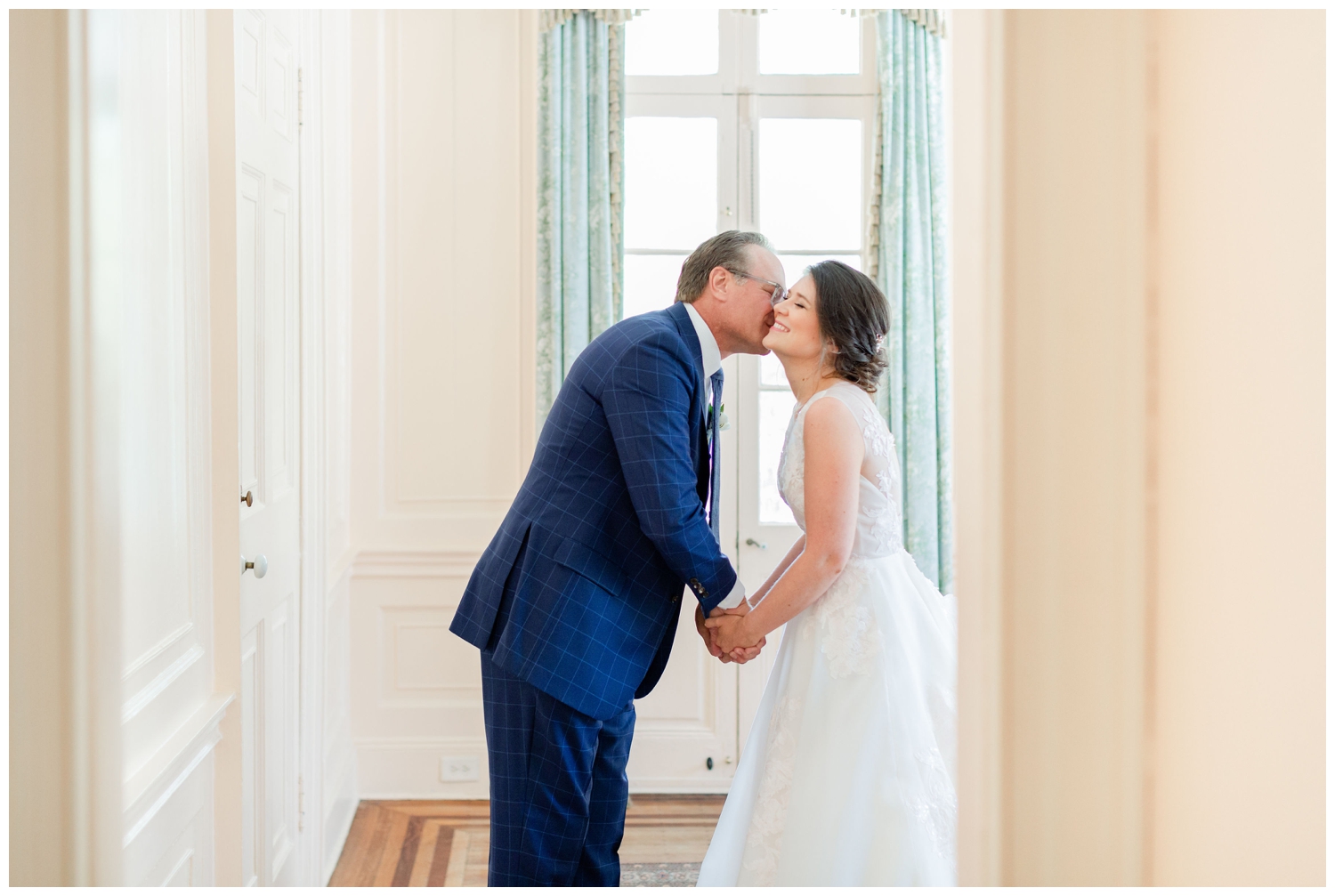 bride and father kissing after first look inside Lowndes Grove in Charleston