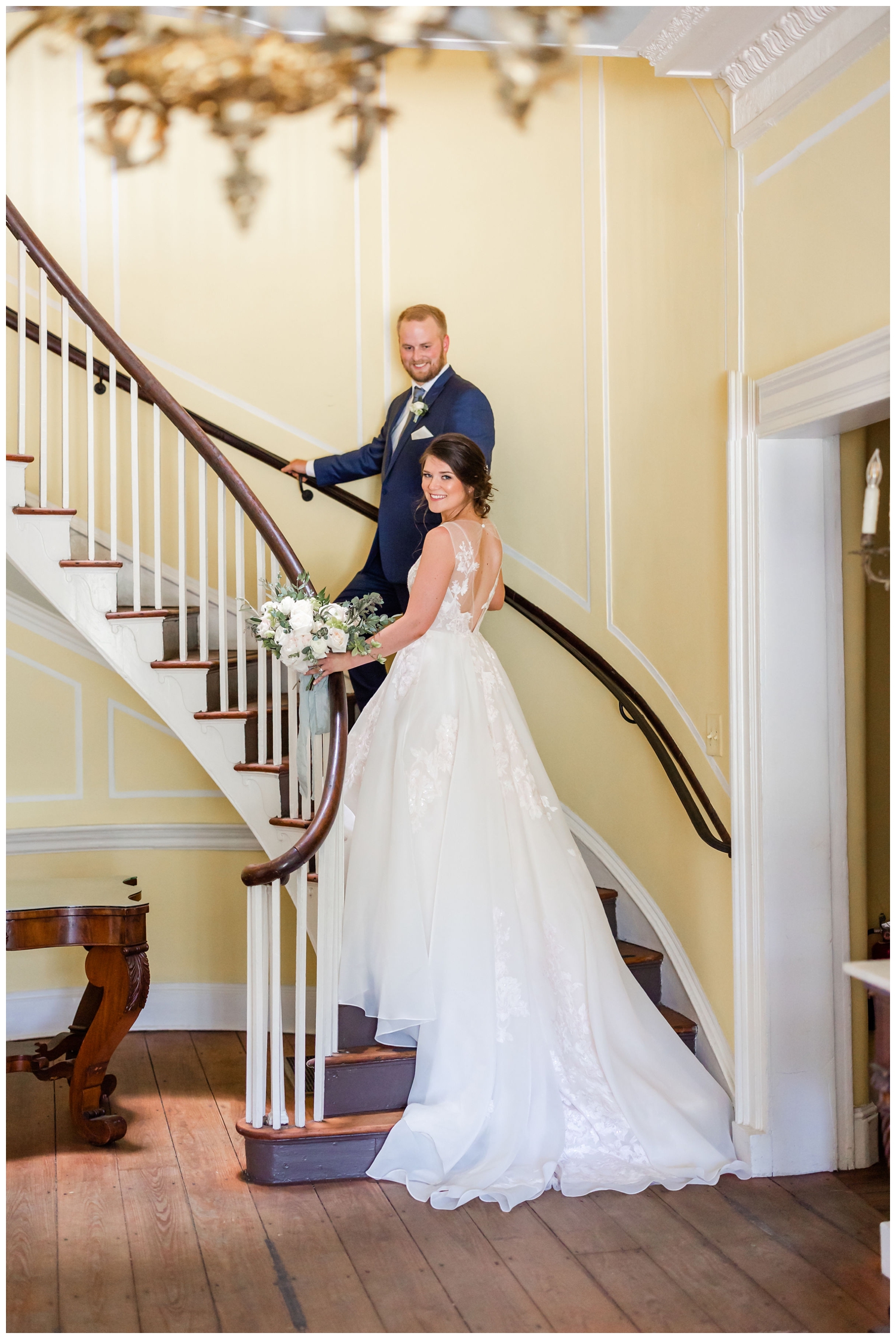 bride and groom walking up staircase inside Lowndes Grove in Charleston