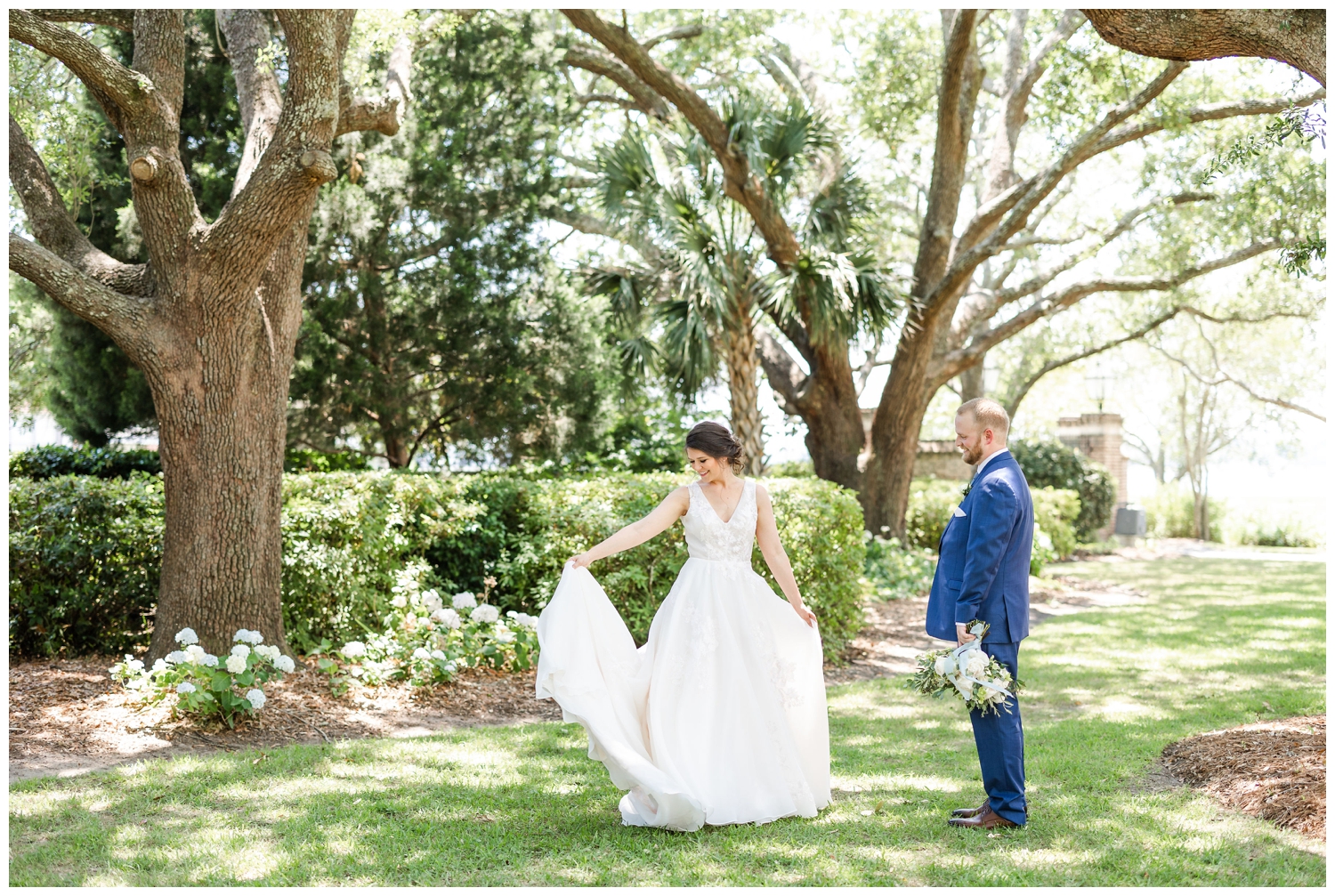 bride and groom portrait with bride twirling dress at Lowndes Grove under live oak tree