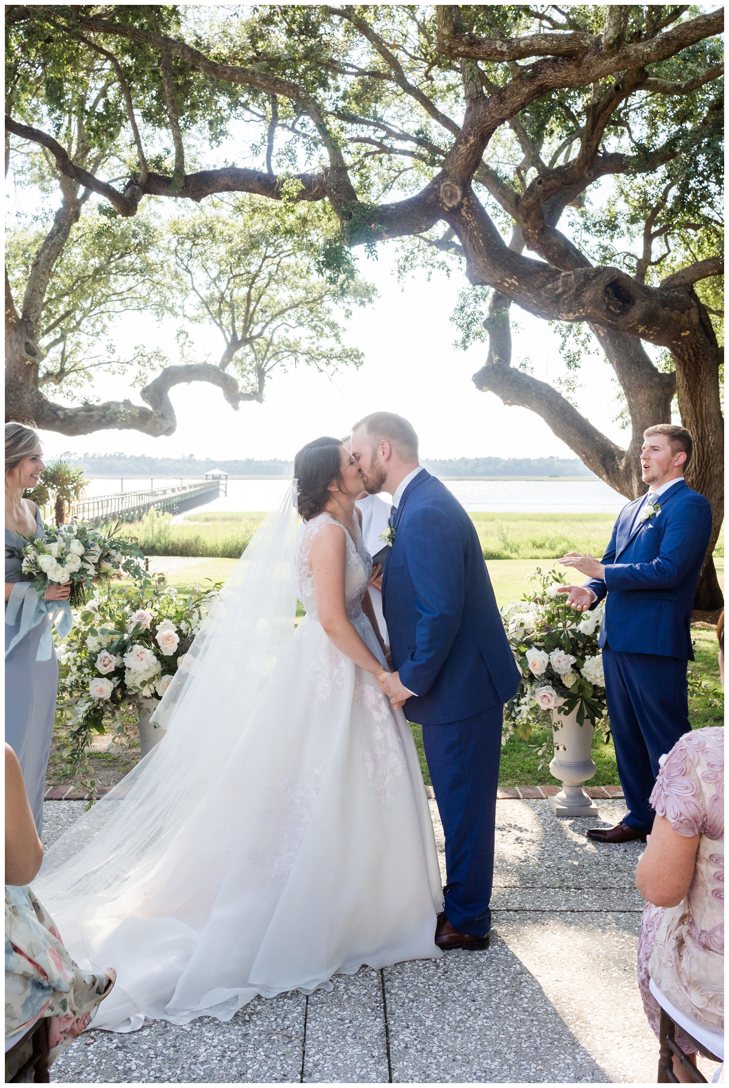 first kiss for bride and groom during spring Lowndes Grove wedding ceremony