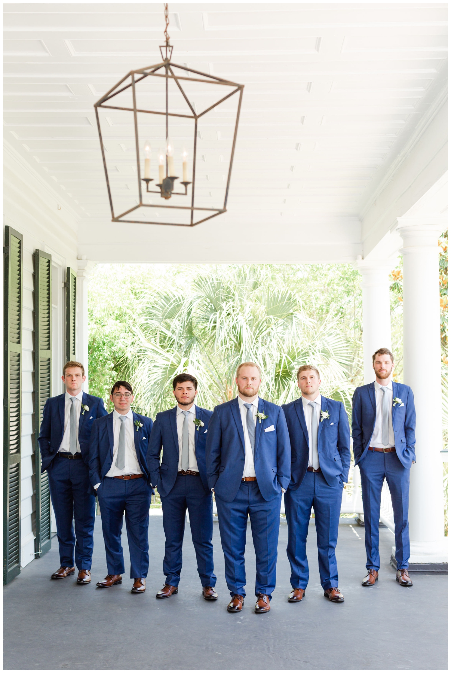 groom and groomsmen standing together for portrait at spring Lowndes Grove wedding