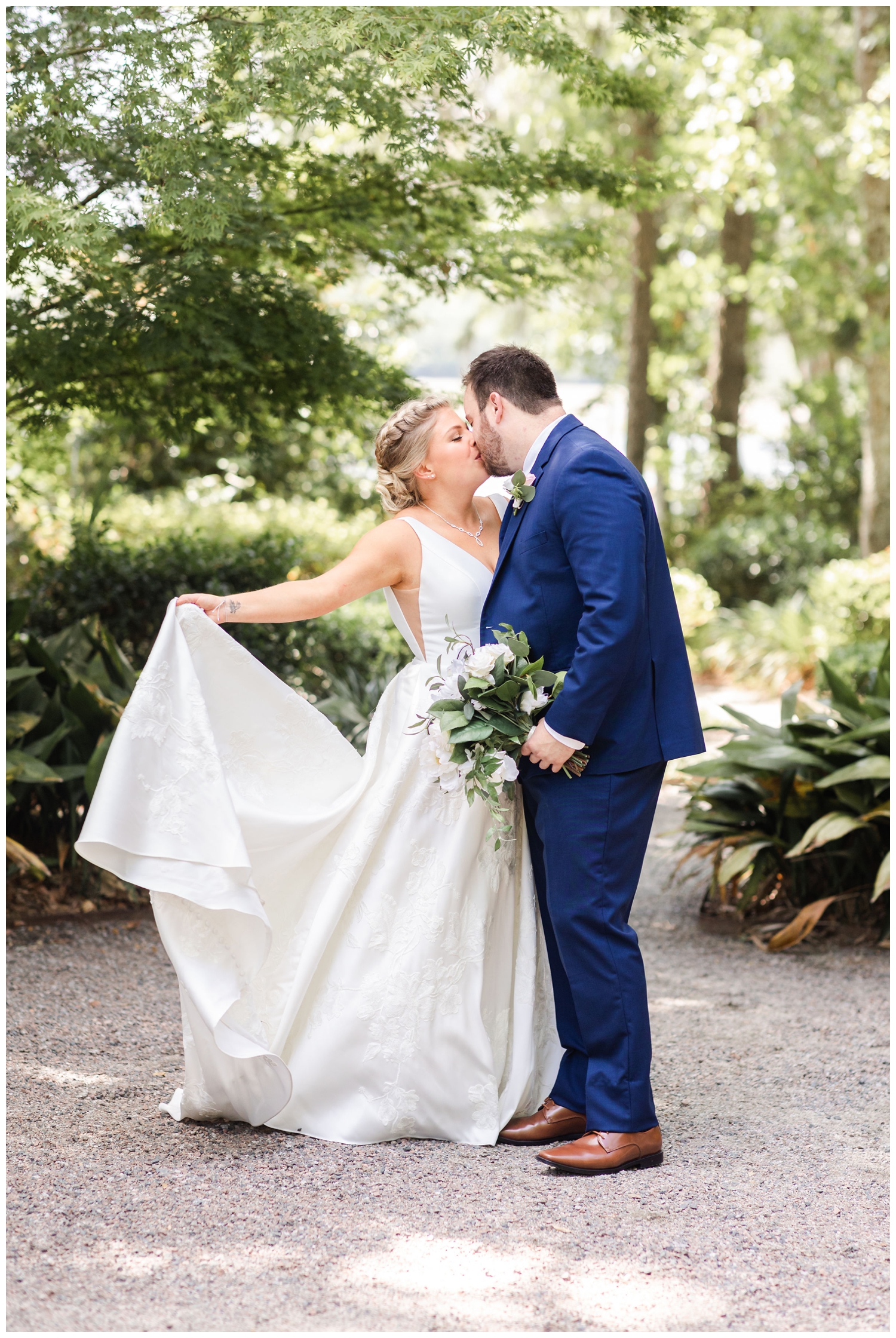 bride and groom kissing under the trees outside summer Creek Club at I'on wedding