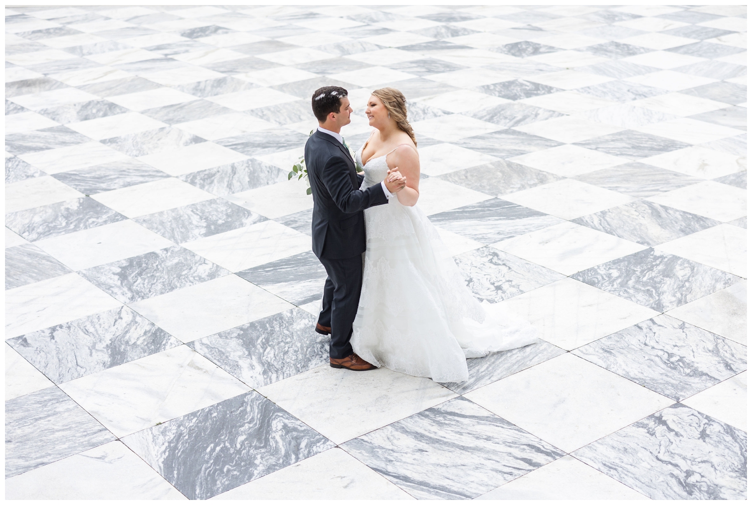 bride and groom dancing on white gray patterned floor at Charleston Merchants Hall