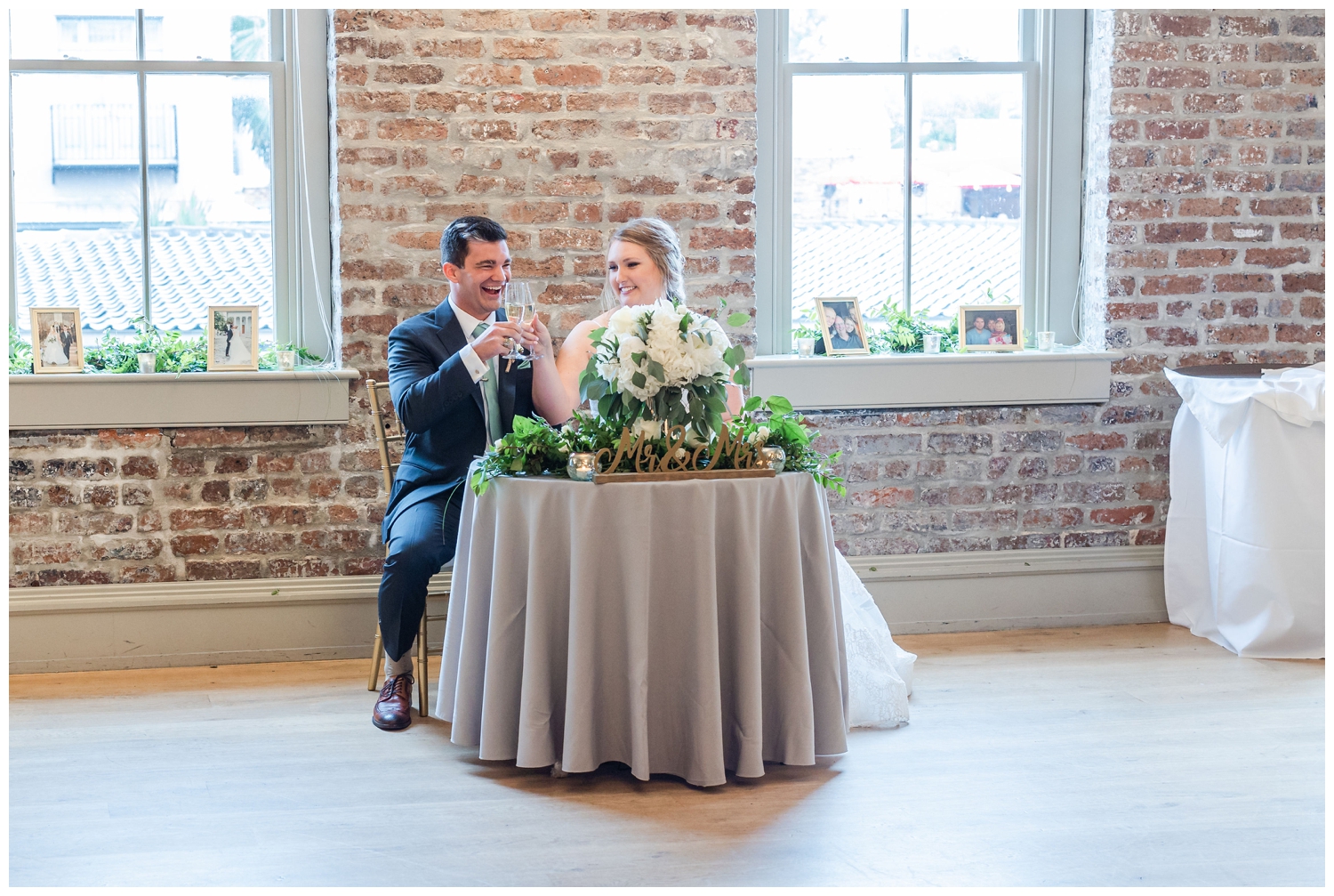 bride and groom toasting at sweetheart table Charleston Merchants Hall Reception