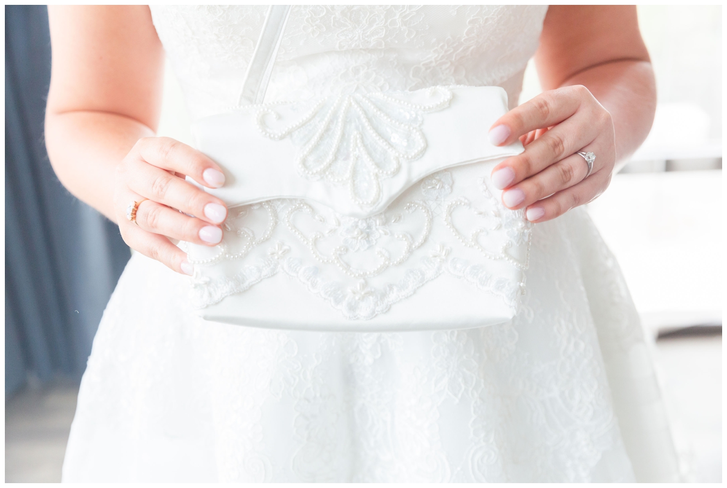 bride holding white purse
