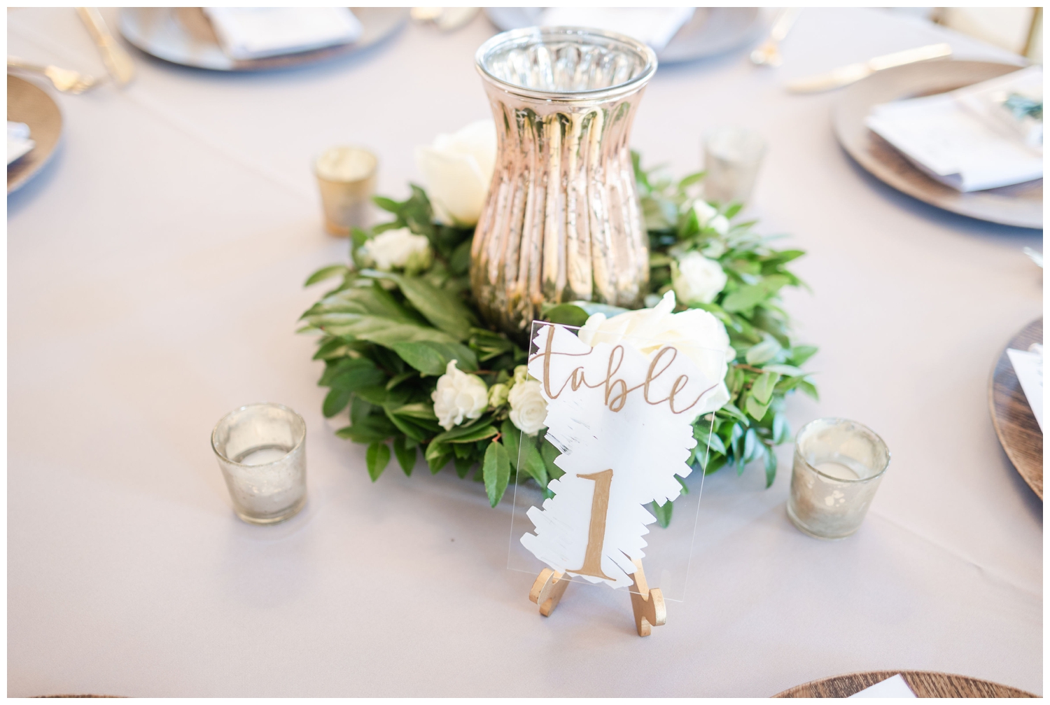 white and gold table number and centerpiece
