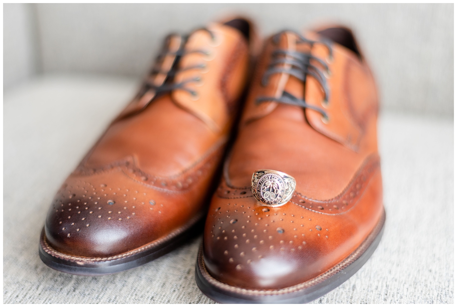 groom brown shoes with ring on top