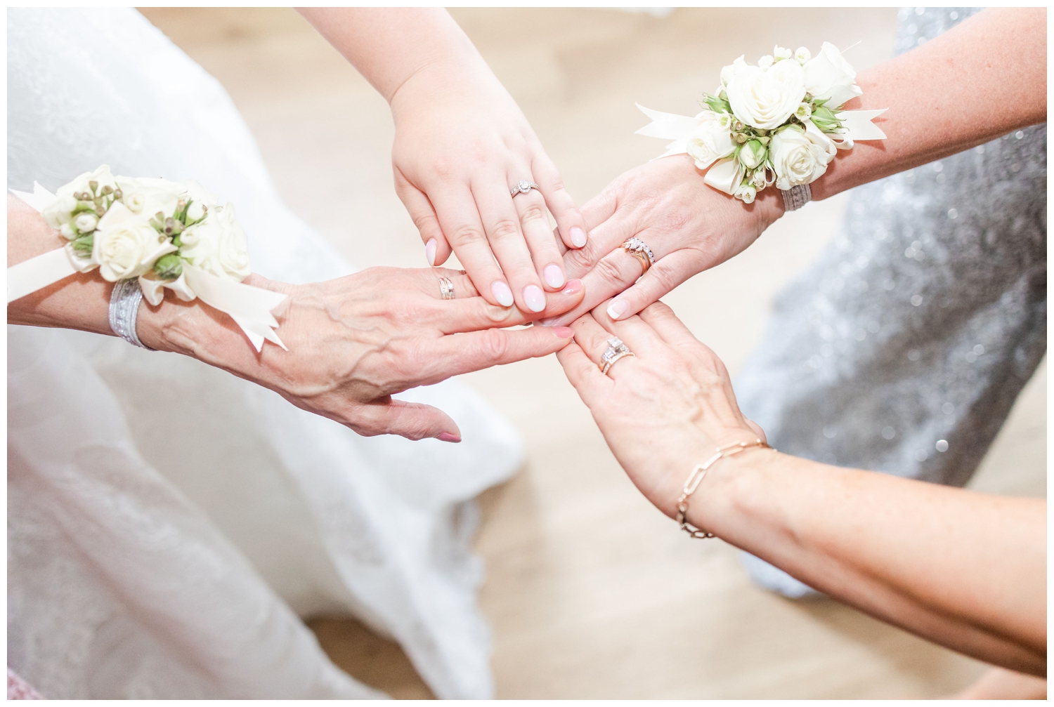 detailed shot of four hands with wedding rings