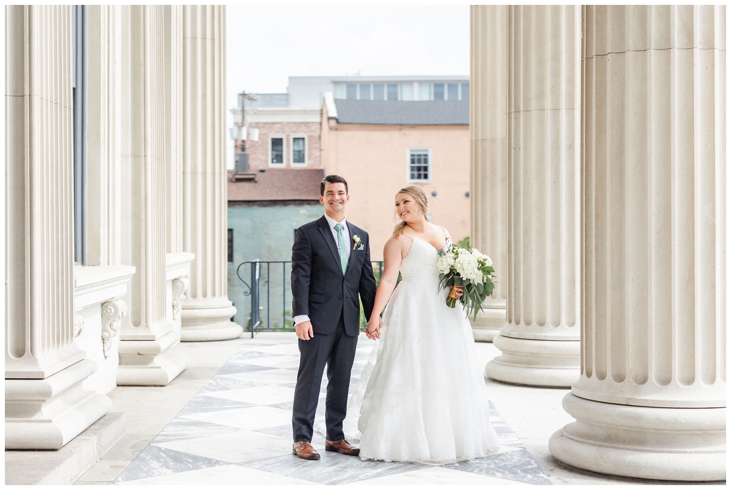 bride and groom standing outside Charleston Merchants Hall