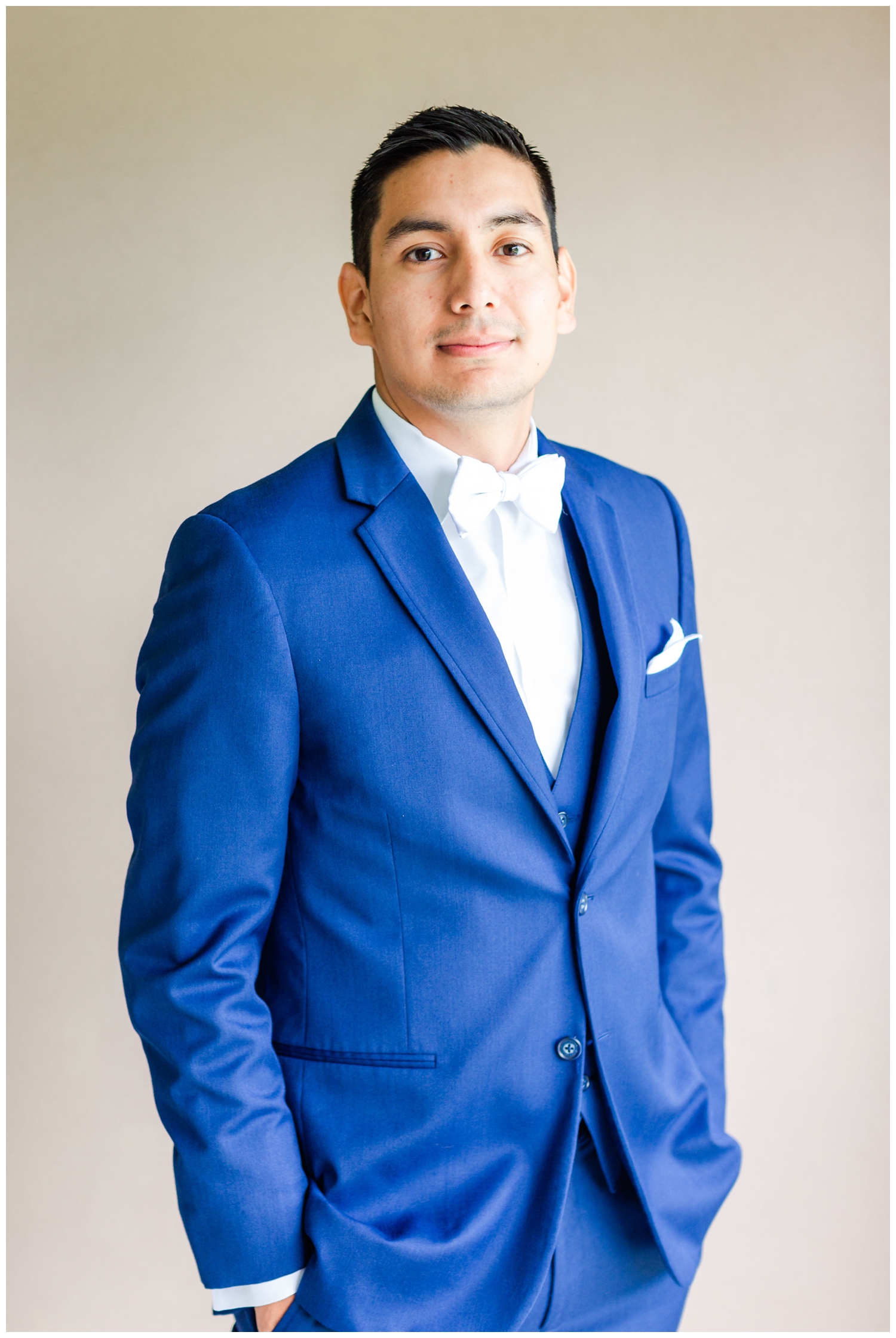 groom portrait standing in blue suit