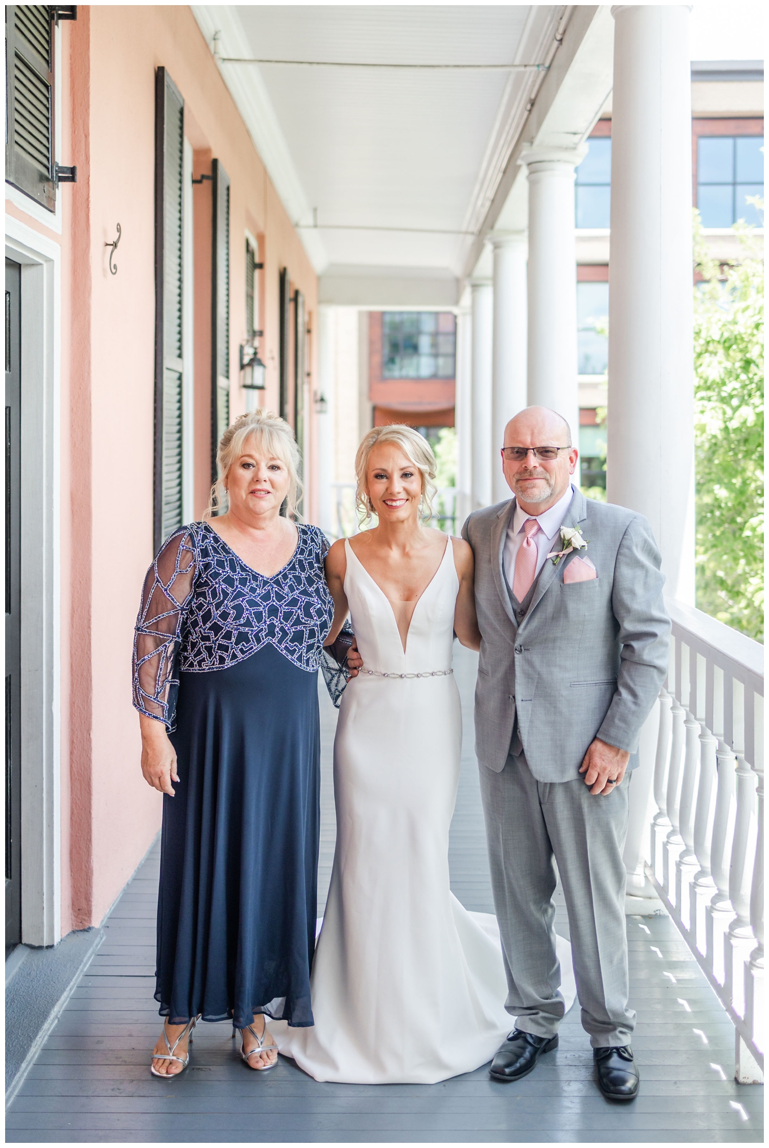 bride and parents on white veranda for southern summer wedding charleston
